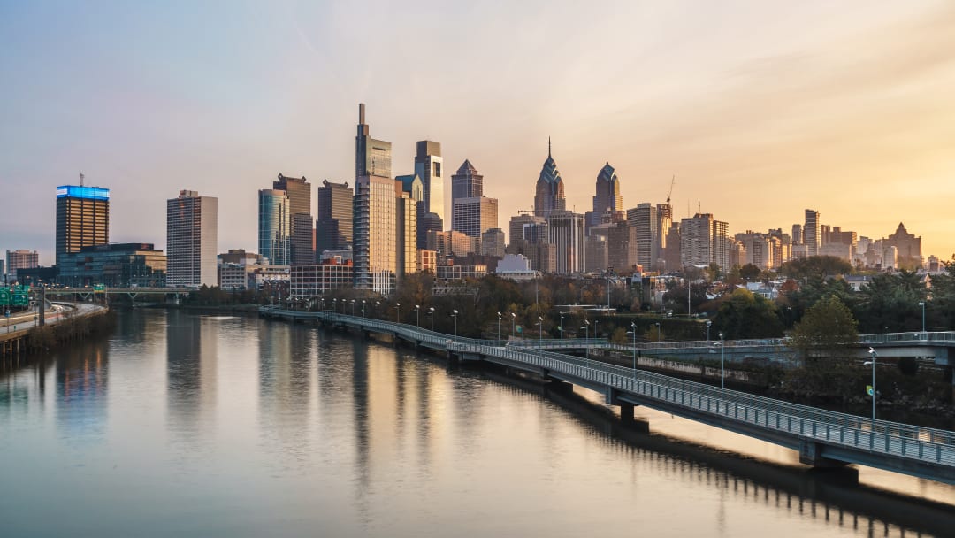 View of Philadelphia's skyline with the Delaware River in the foreground.