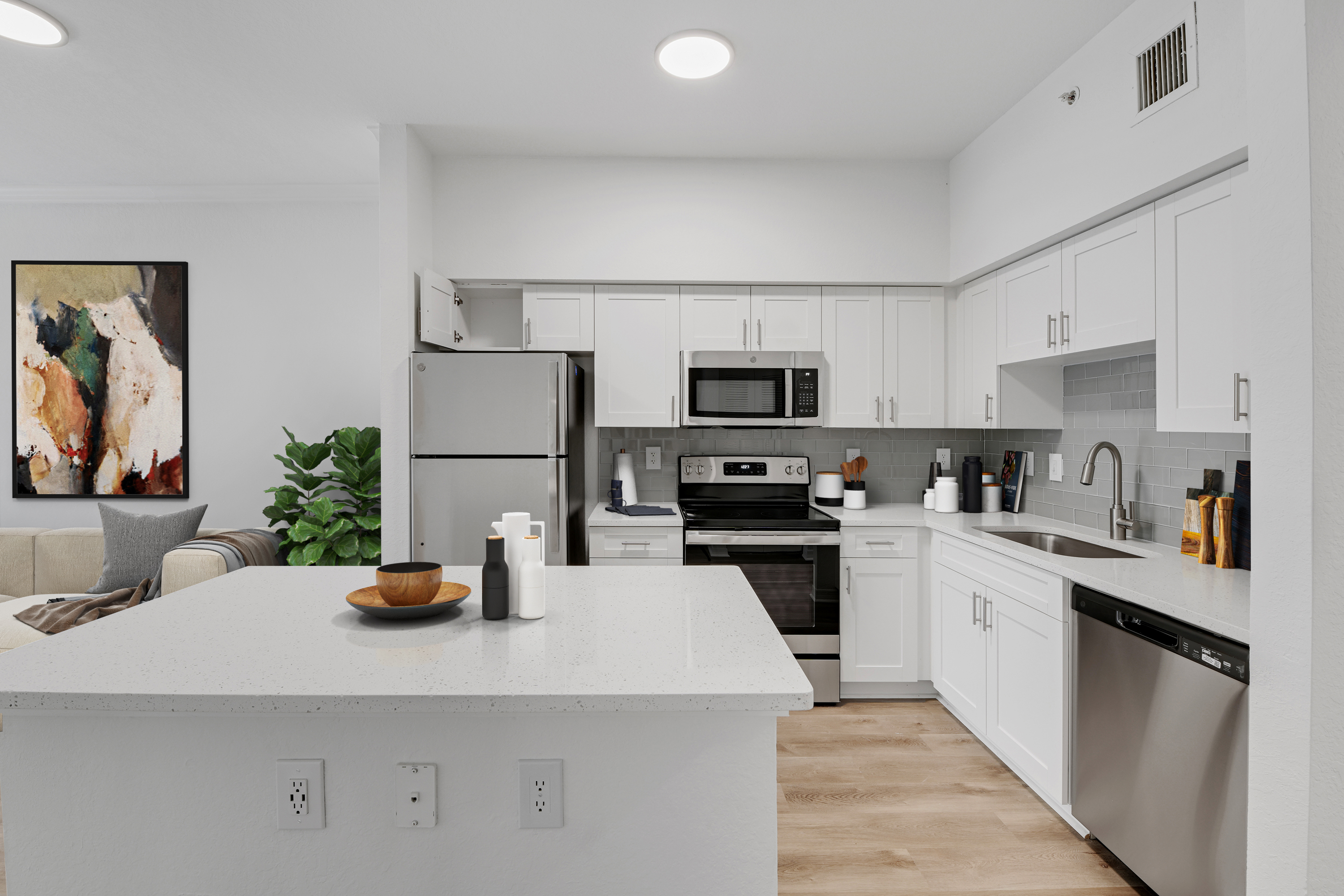 new kitchen renovation with white cabinetry and light quartz countertops