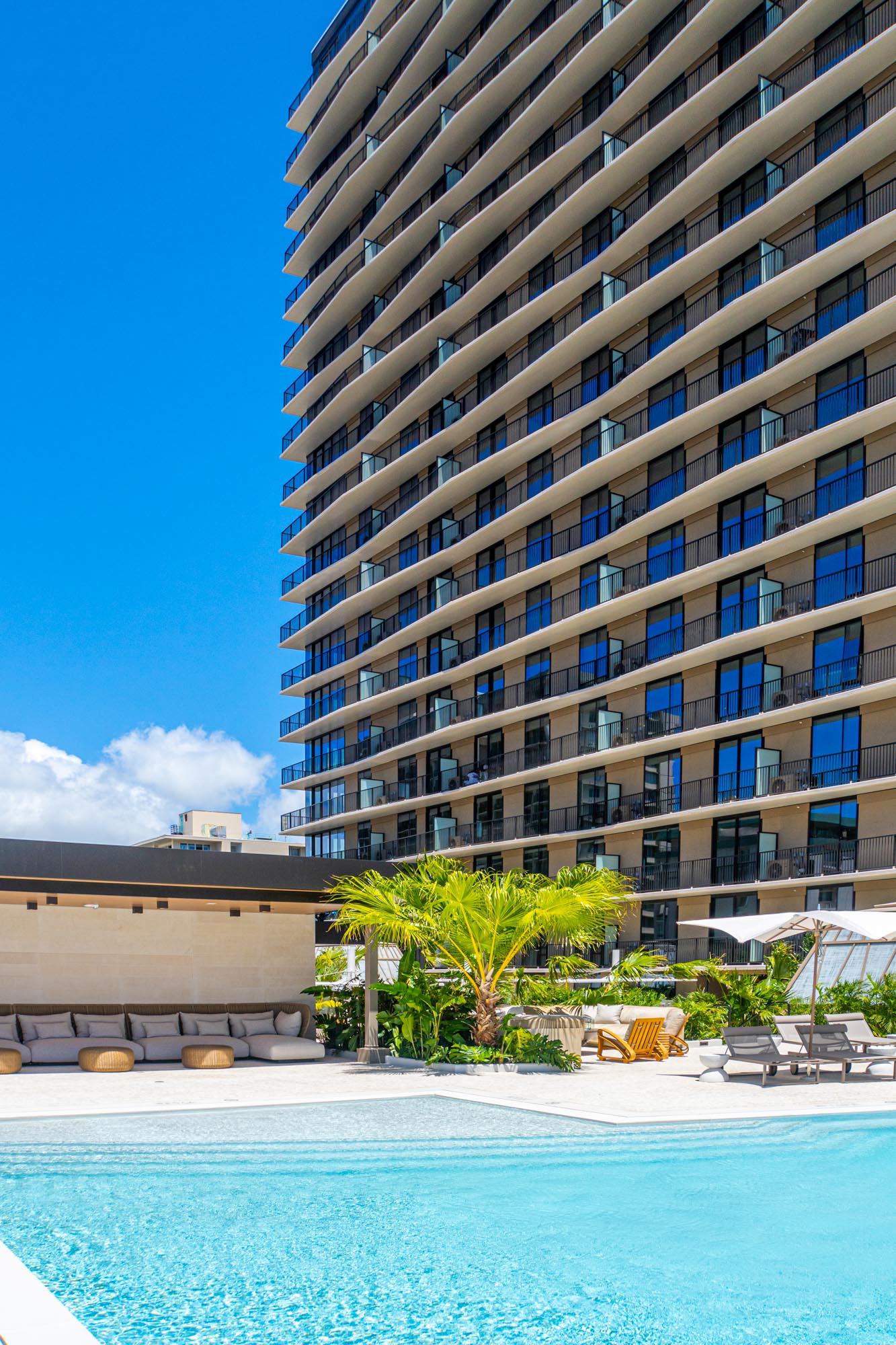 View of Lilia's apartment building exterior from the pool area.