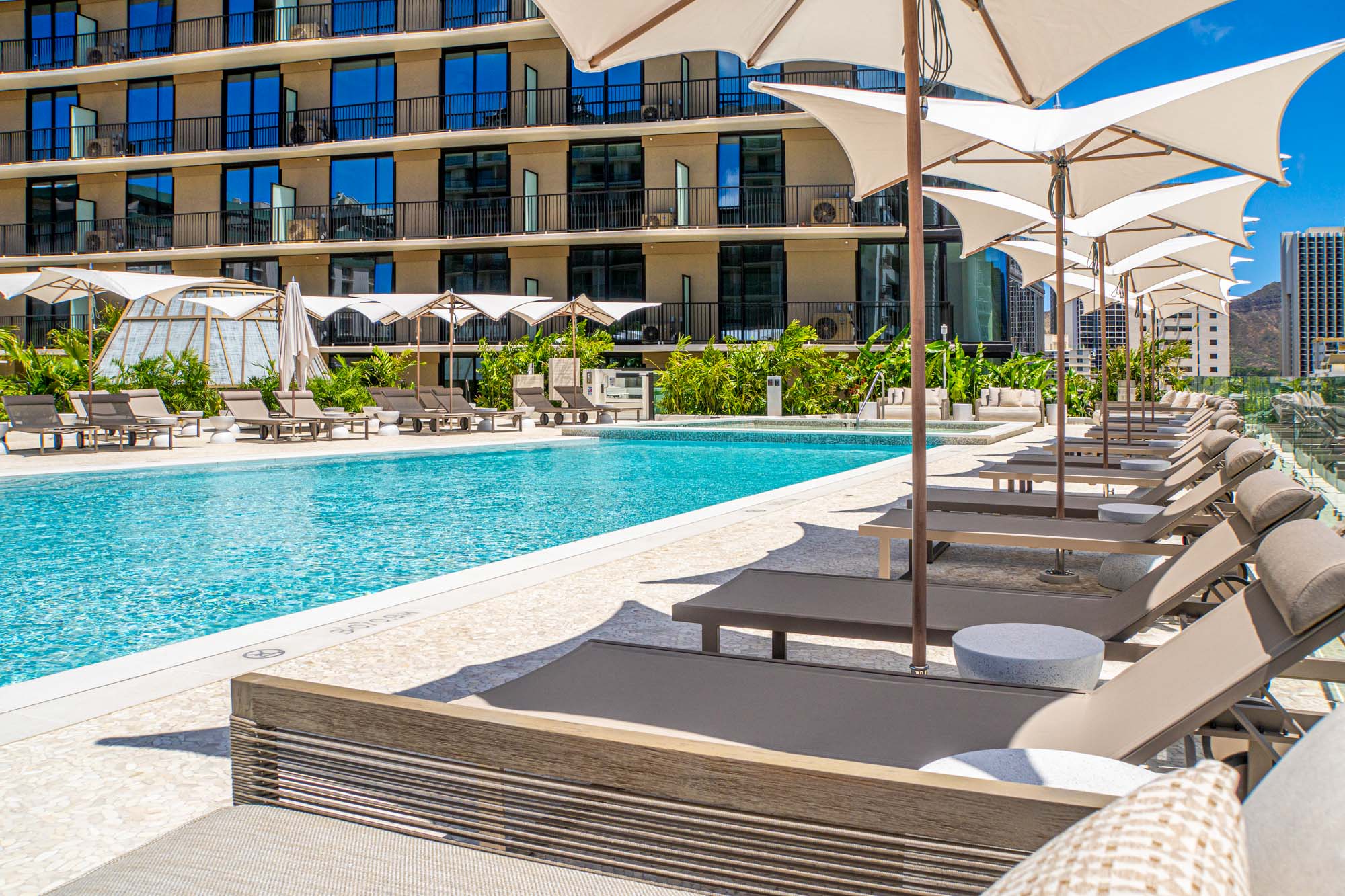 Resort-style pool surrounded by lounge chairs.