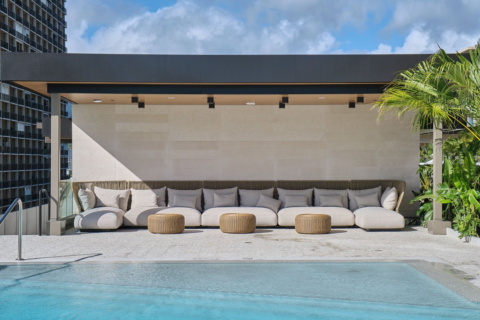 Resort-style pool with cabana area with plush seating.