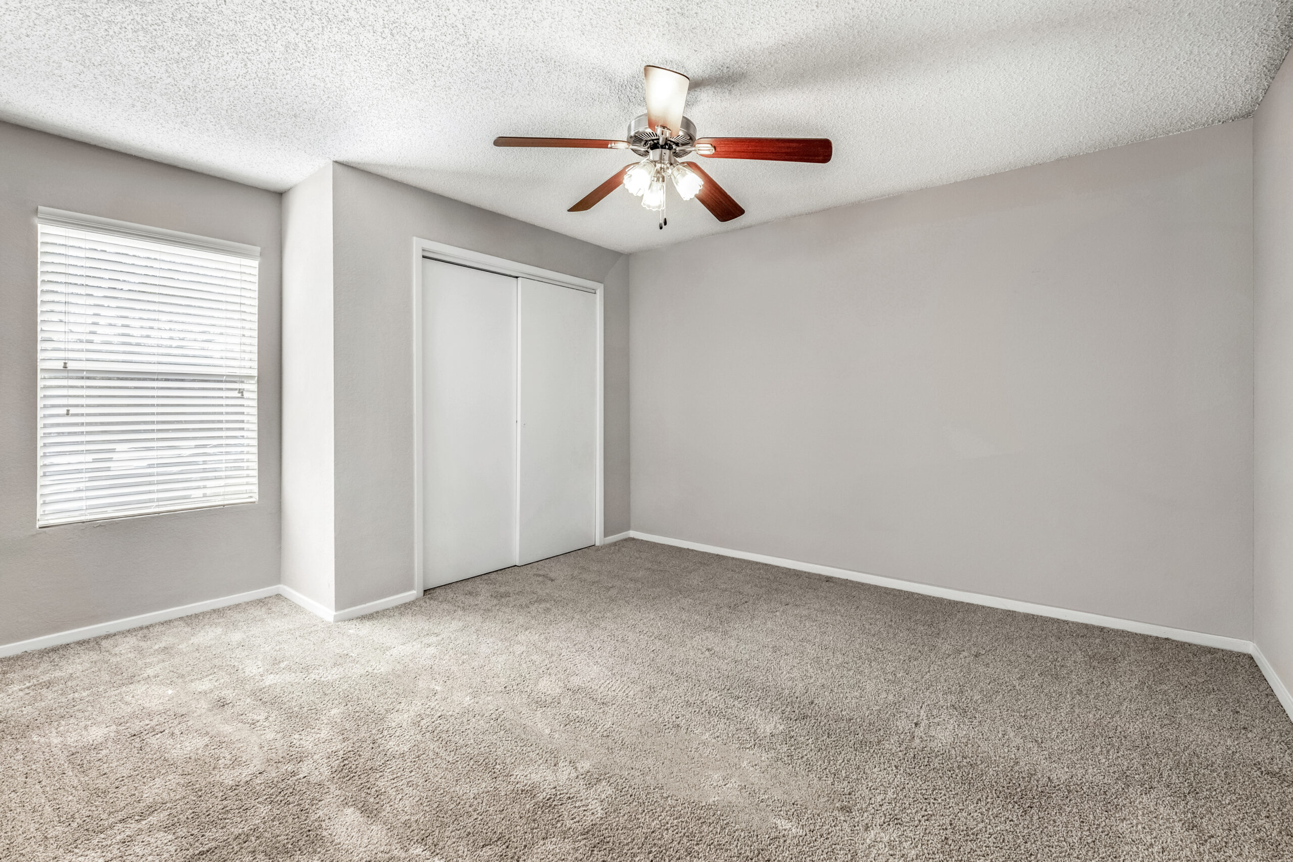 A bedroom at Brookwood Club apartments in Jacksonville, FL.