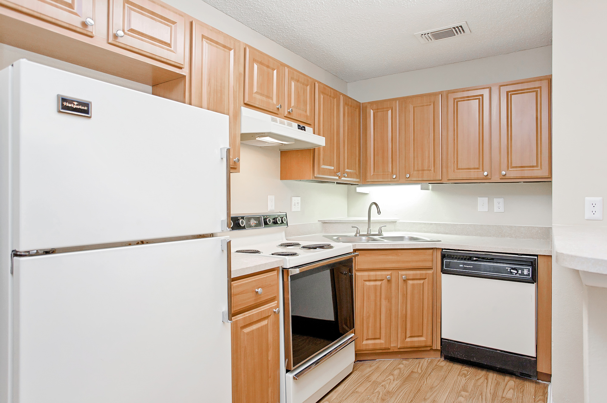 The kitchen of an apartment at The Arbors of Wells Branch in Austin, TX.