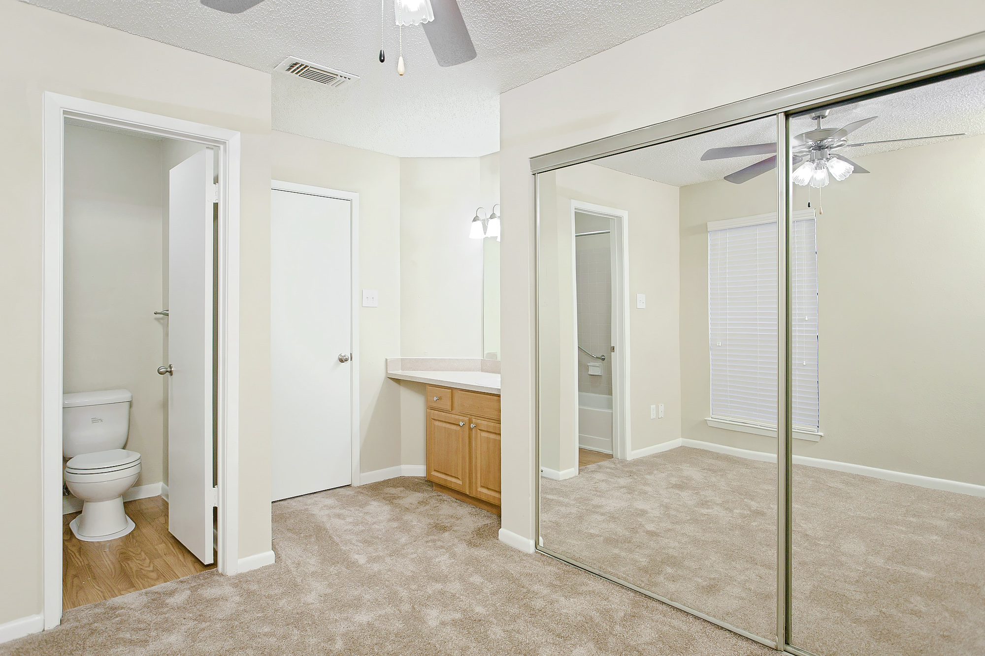 The bedroom of an apartment at The Arbors of Wells Branch in Austin, TX.