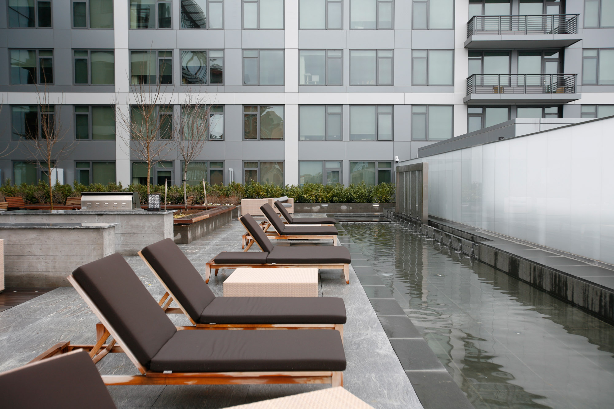 The outdoor terrace with lounges and water feature at Twelve12 in Navy Yard, Washington DC.