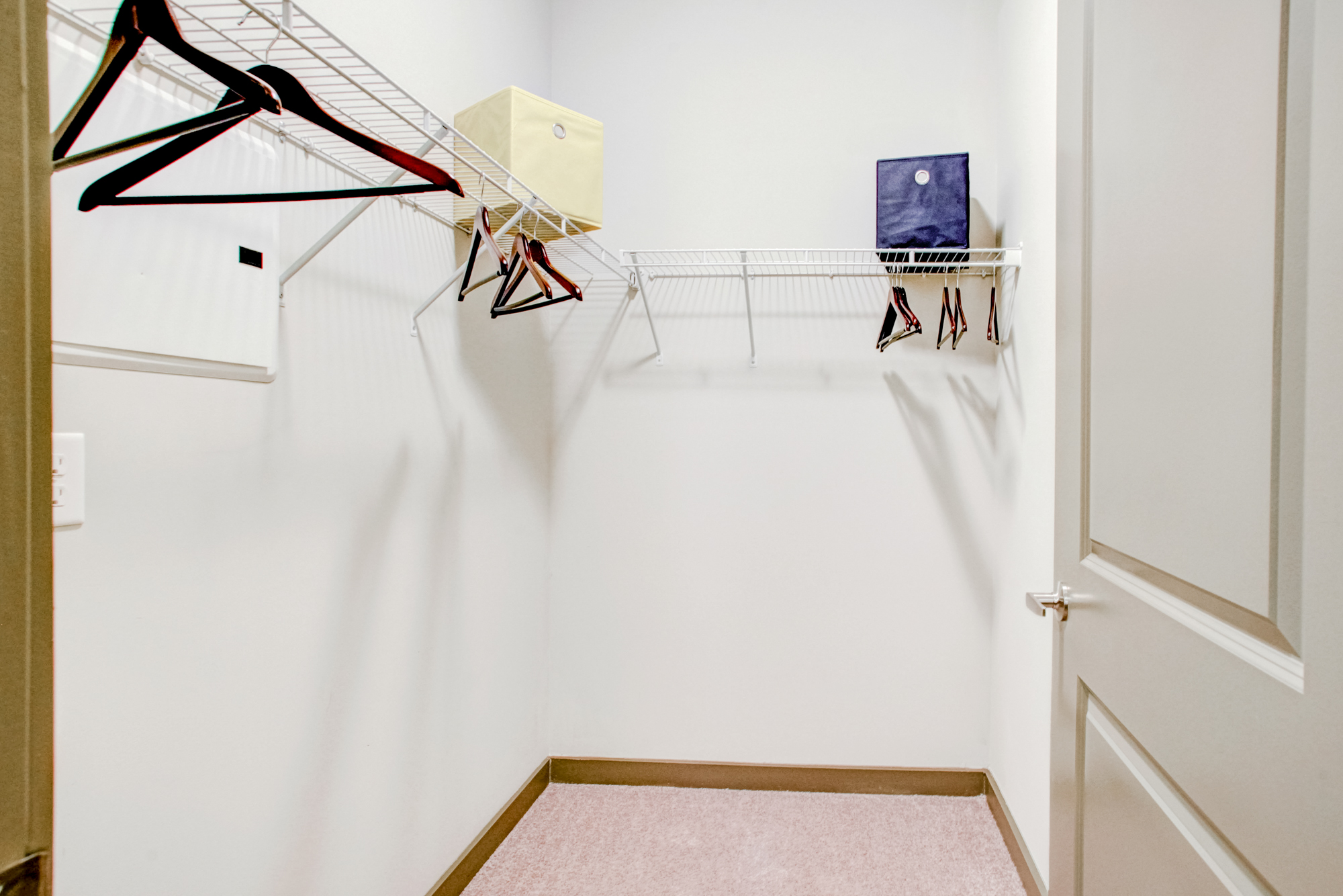 A walk-in closet with hangers at Park 9 apartments near Atlanta, GA.