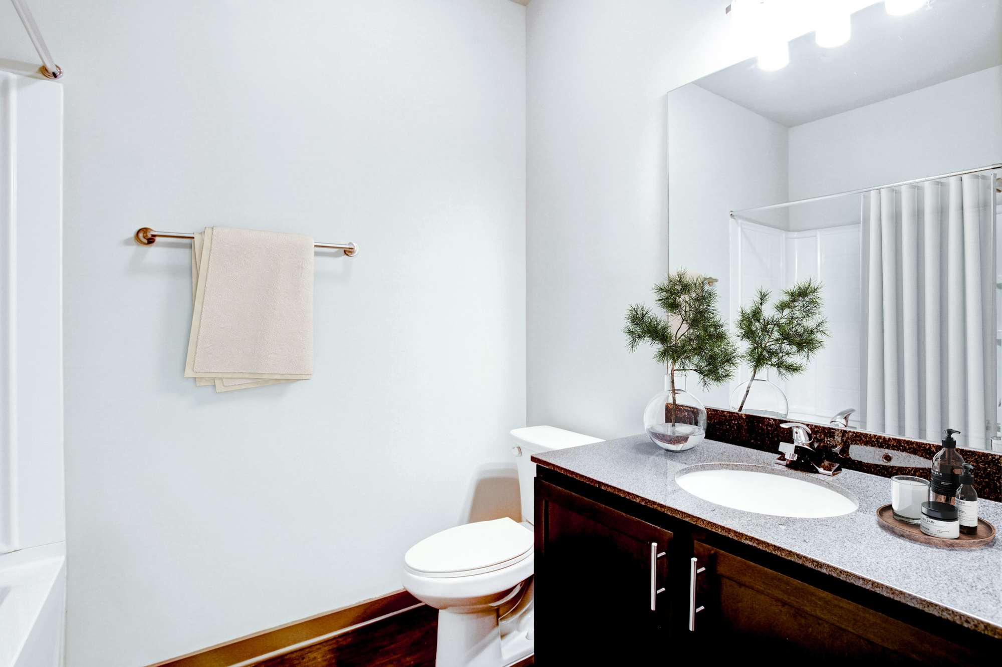 A kitchen sink and toilet are in the bathroom at Park 9 apartments in Woodstock, GA.