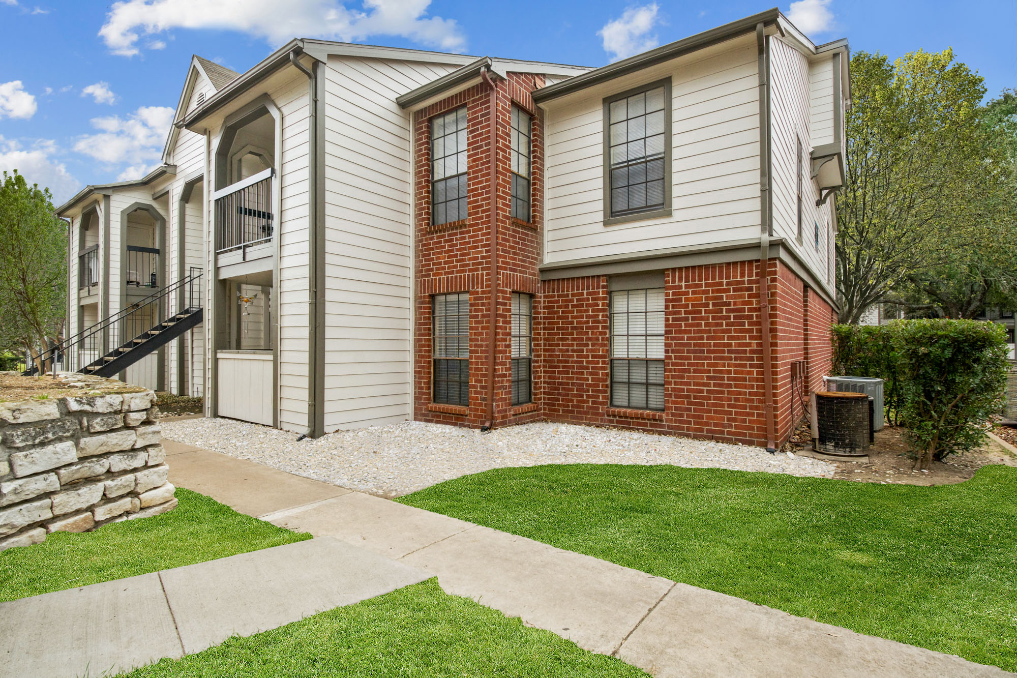 The exterior of an apartment building at The Arbors of Wells Branch in Austin, TX.