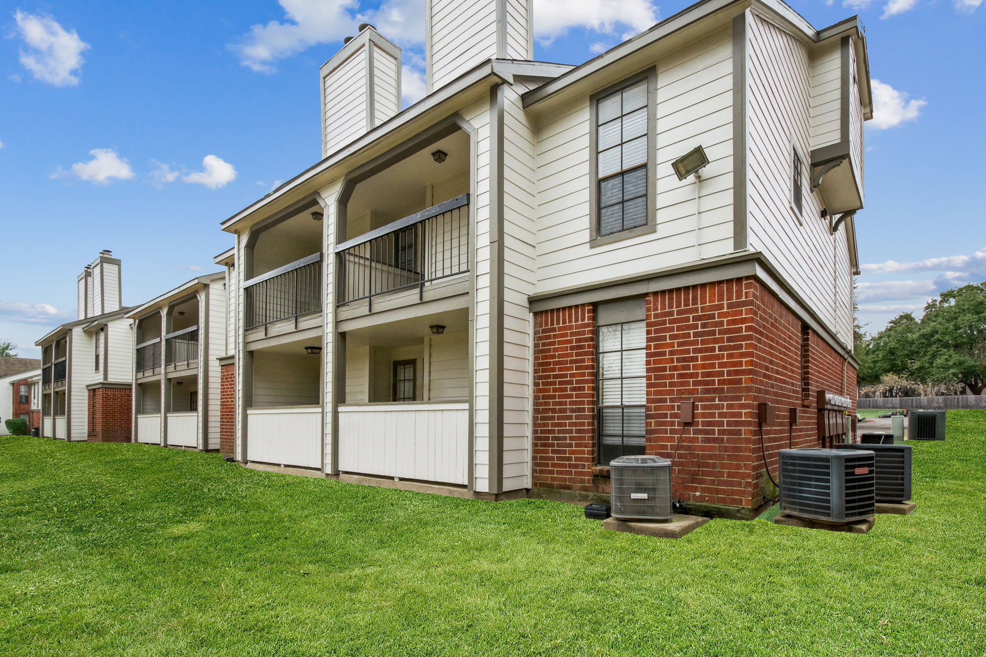 The exterior of an apartment building at The Arbors of Wells Branch in Austin, TX.