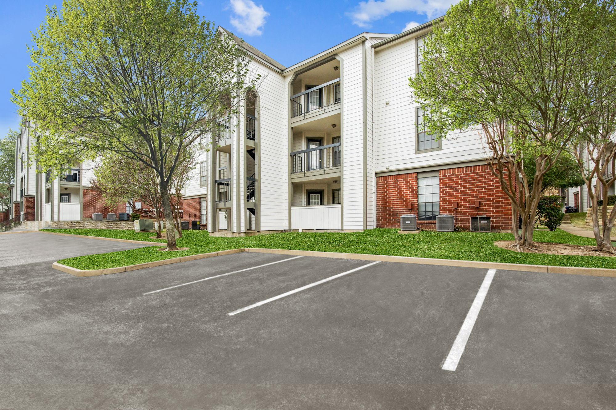 The exterior of an apartment building at The Arbors of Wells Branch in Austin, TX.