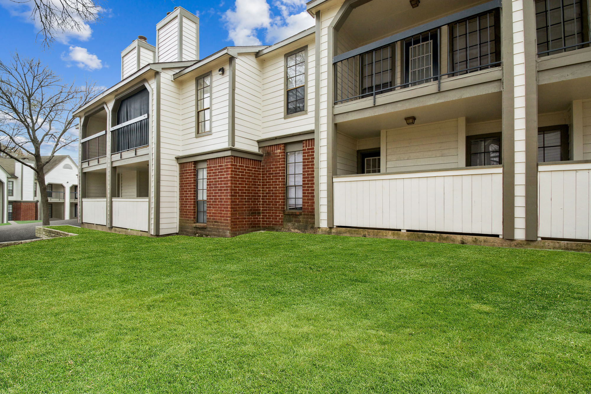 The exterior of an apartment building at The Arbors of Wells Branch in Austin, TX.