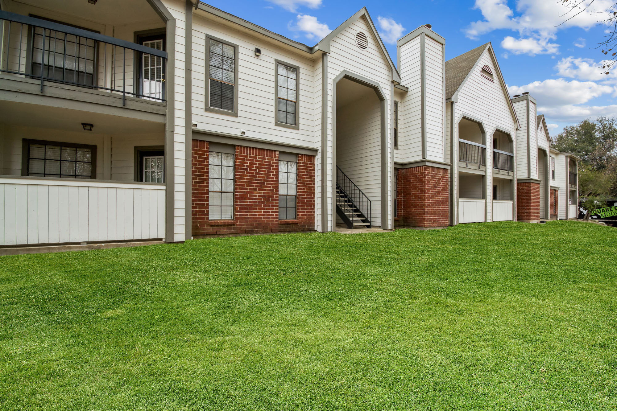 The exterior of an apartment building at The Arbors of Wells Branch in Austin, TX.