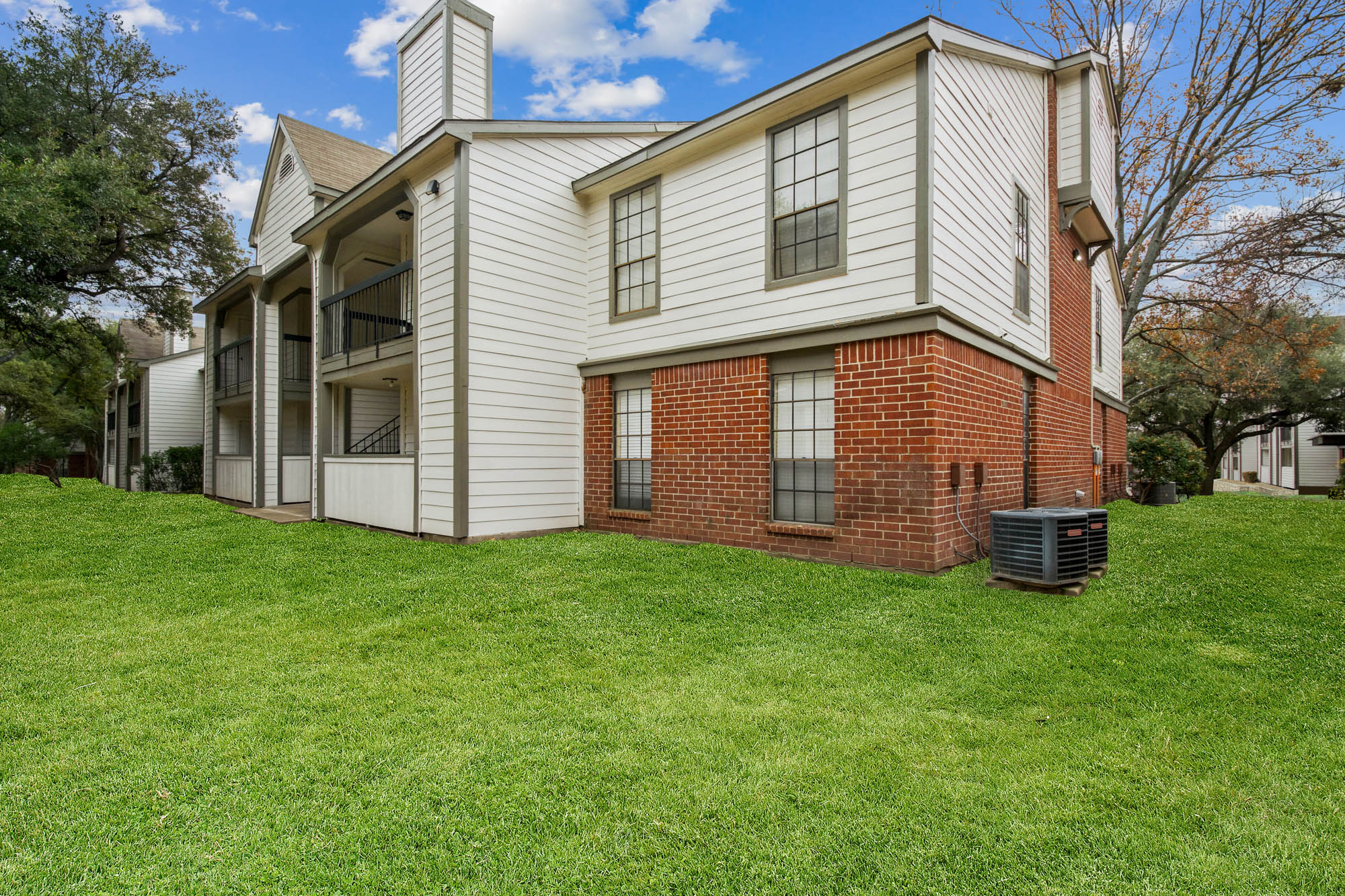 The exterior of an apartment building at The Arbors of Wells Branch in Austin, TX.