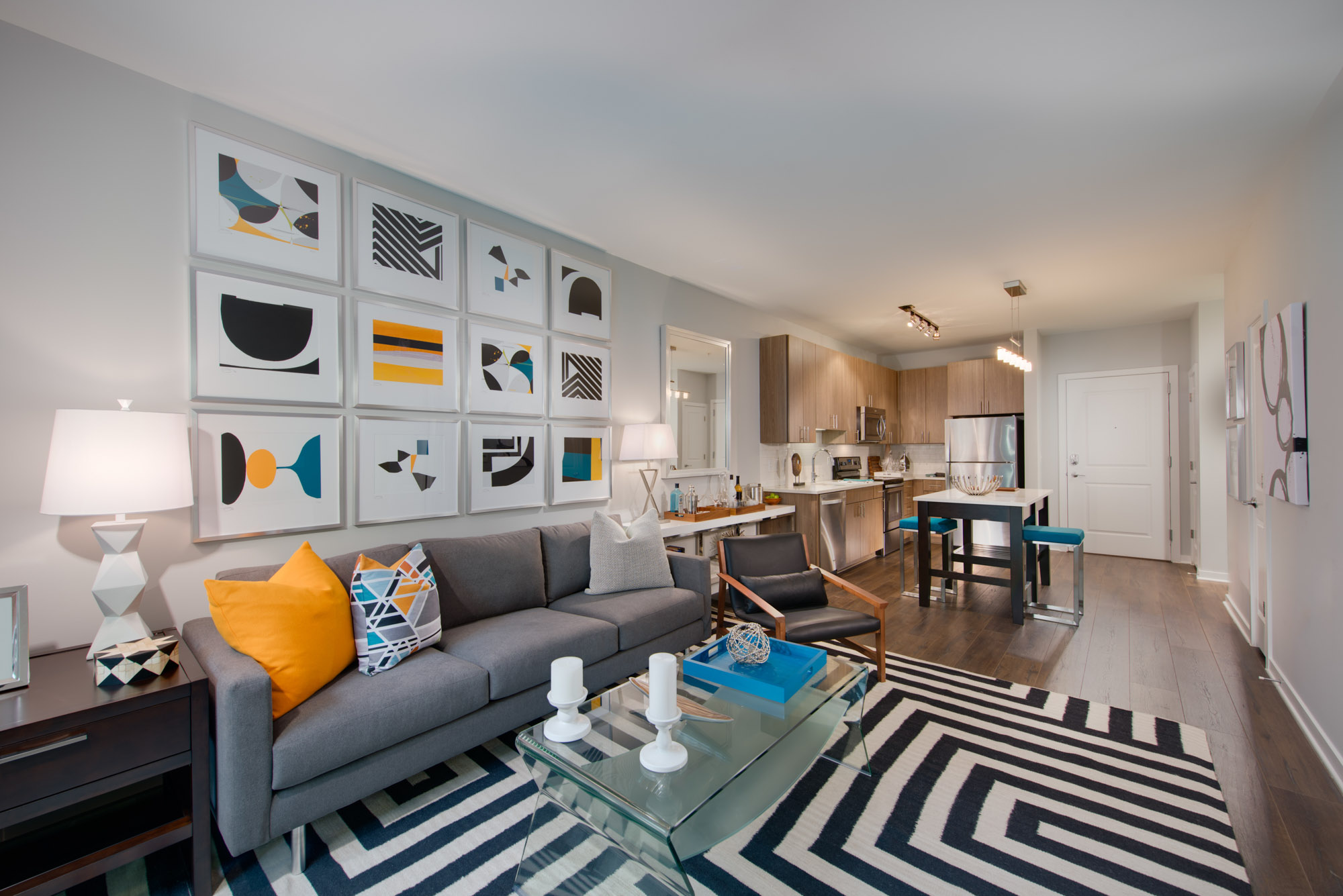 A living room and kitchen in The Parker at Huntington Metro apartment in Alexandria, VA.