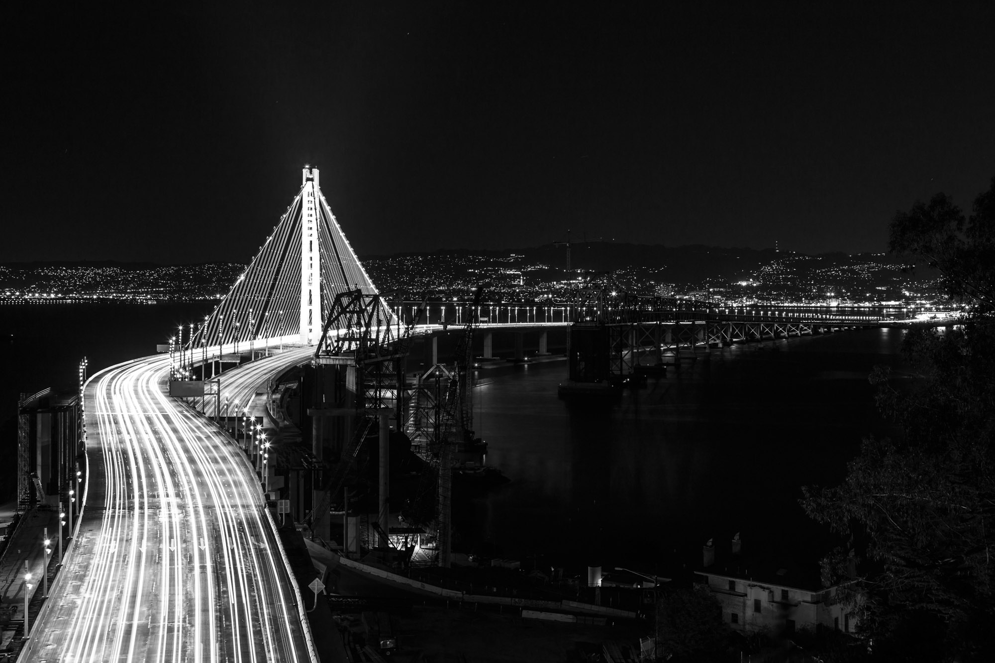 The San Francisco-Oakland Bay Bridge illuminated at night.