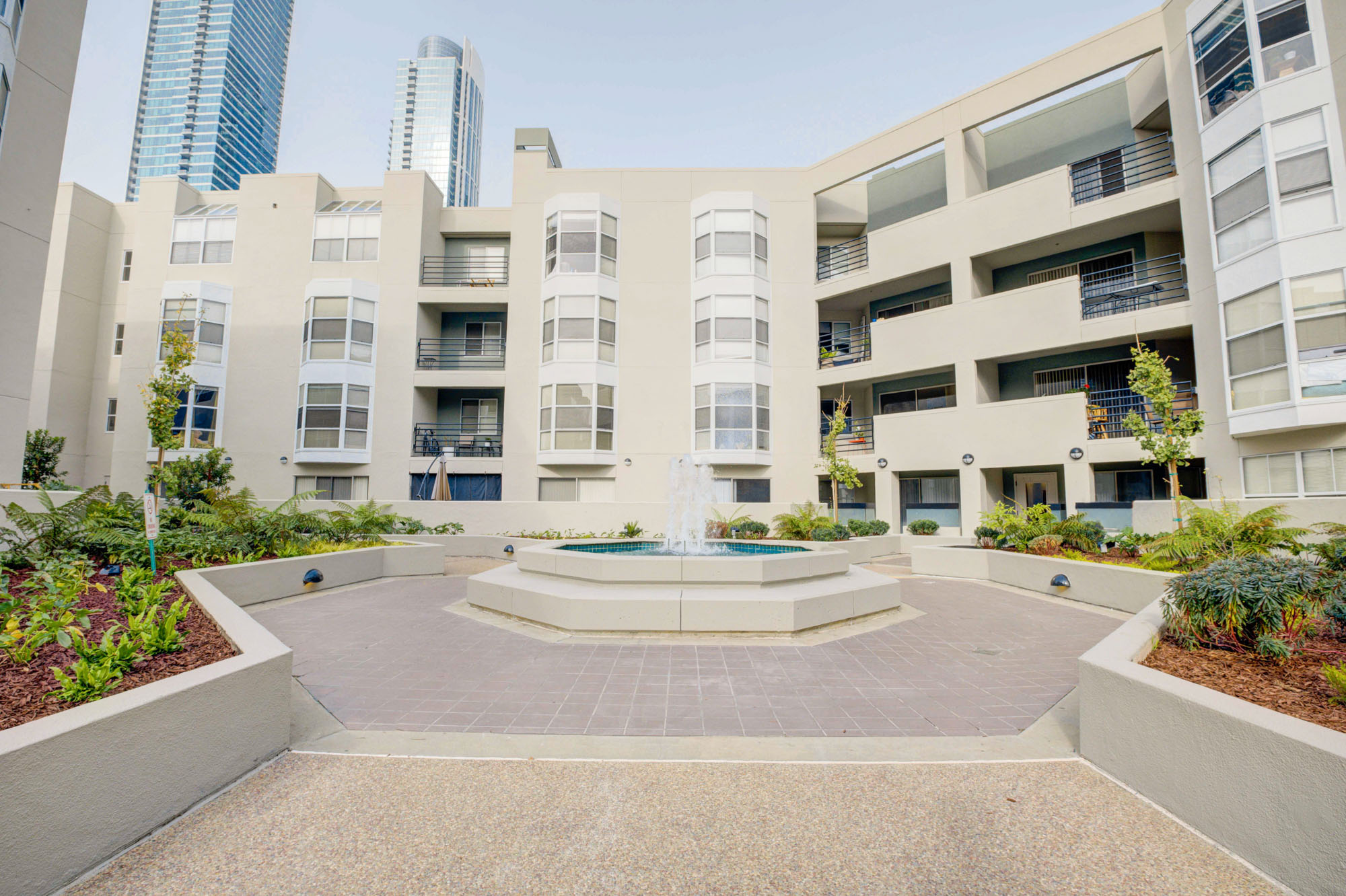A series of connected pathways leading to a water fountain at the center of Bayside Villages apartments in San Francisco