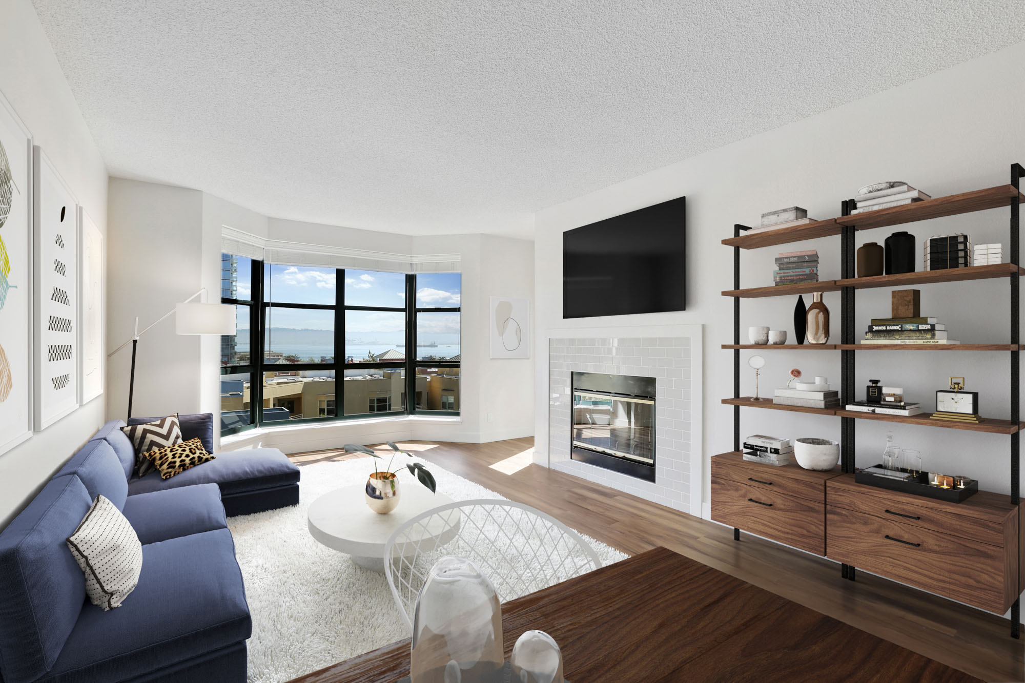 A living room with a fireplace and a bay window at Bayside Village apartments in San Francisco