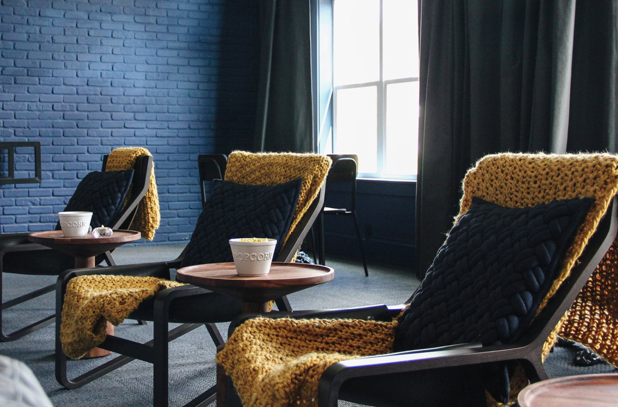 The clubhouse lounge with chairs at Domain apartments in Kissimmee, Florida.