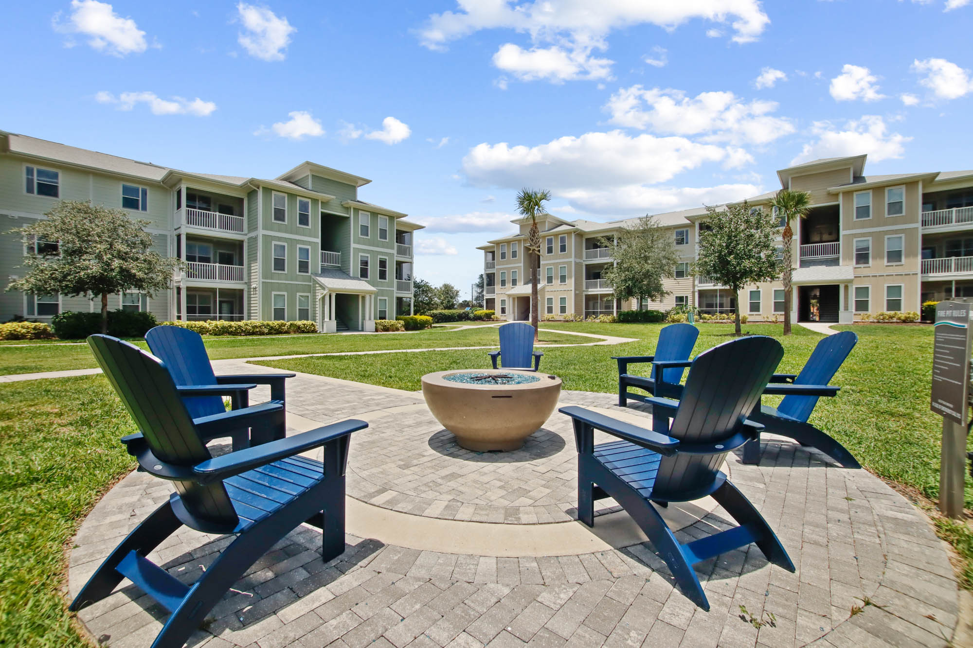The fire pit with chairs around it at Domain apartments in Kissimmee, Florida.