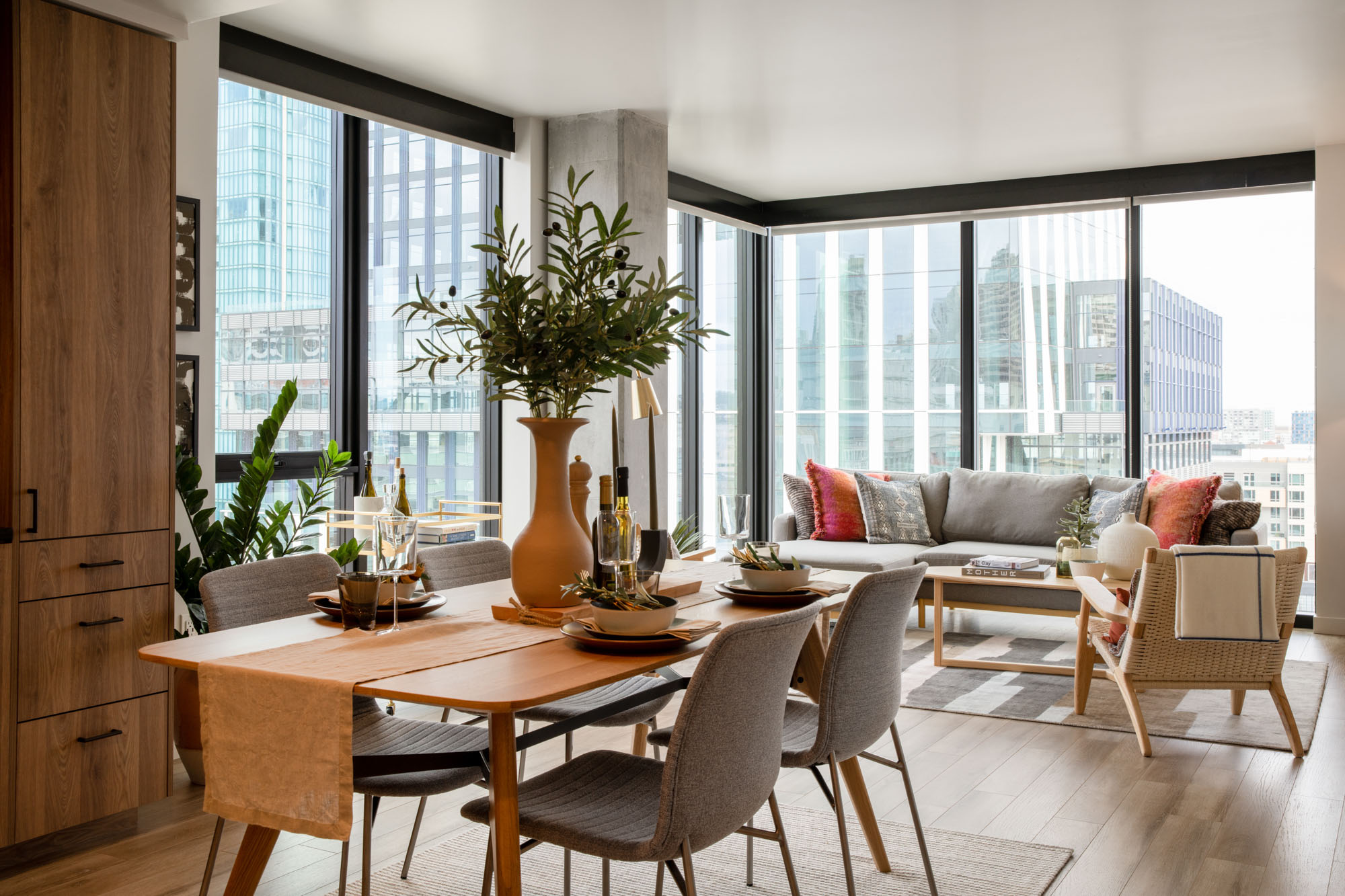 A dining area in an apartment with floor to ceiling windows in the living room at the George luxury apartments in San Francisco