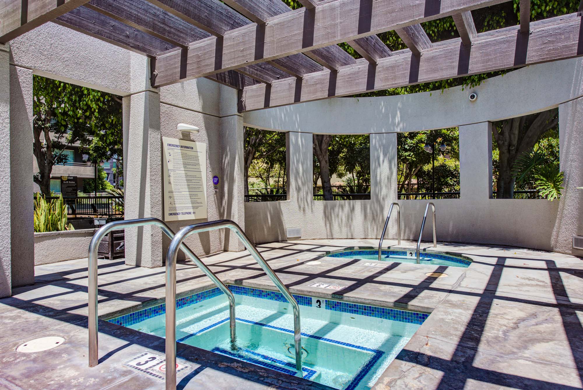 A jacuzzi and hot tubs pool under a pergola at The Met modern apartments in downtown LA