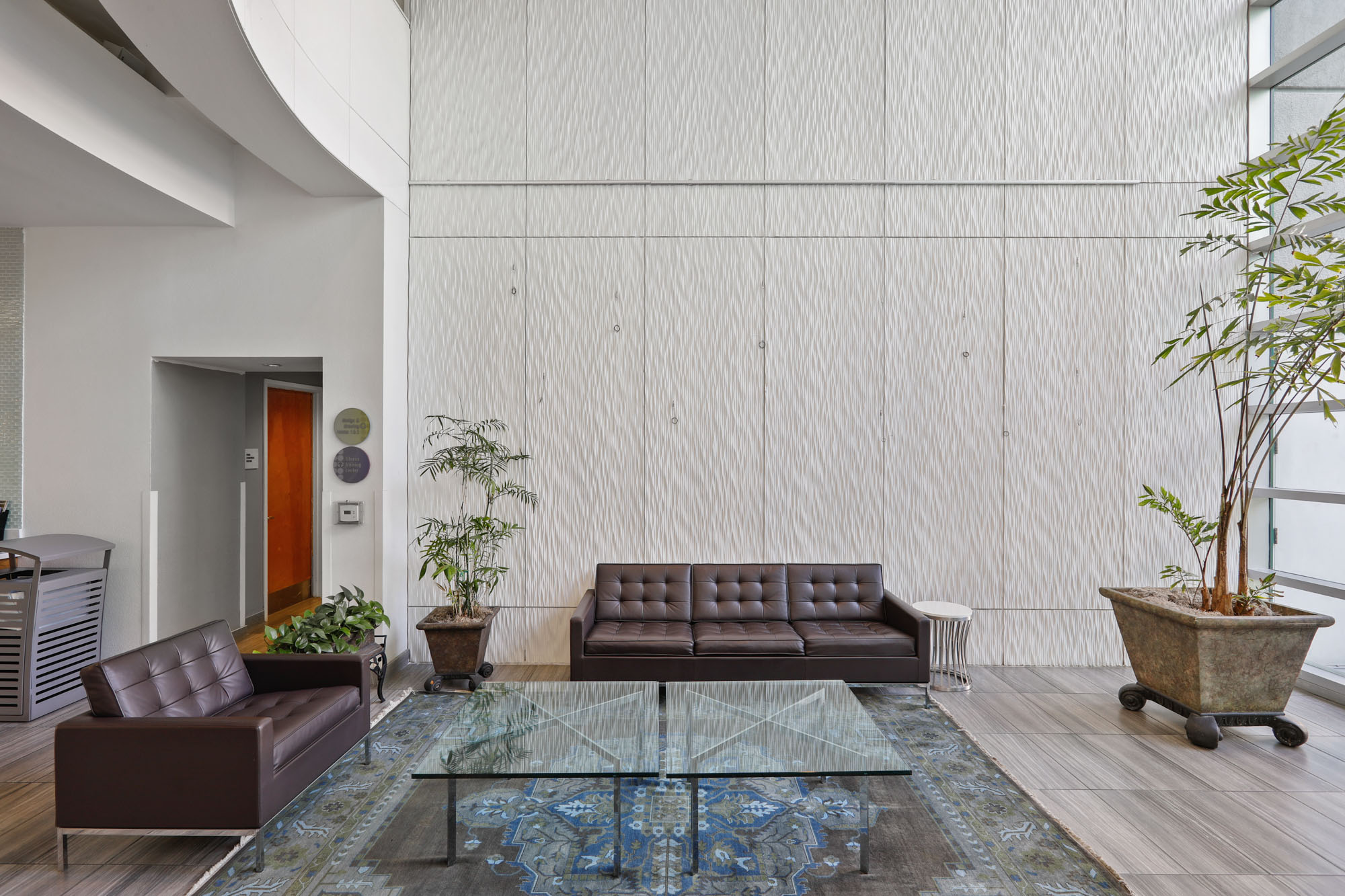 A modern lobby space with two couches for seating at The Met apartments in downtown LA