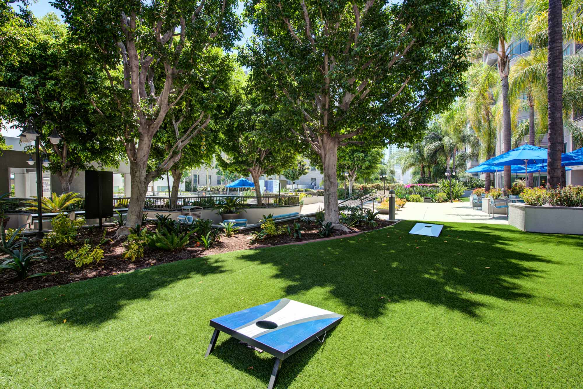 Cornholes on a manicured lawn for entertainment at The Met apartment in downtown LA