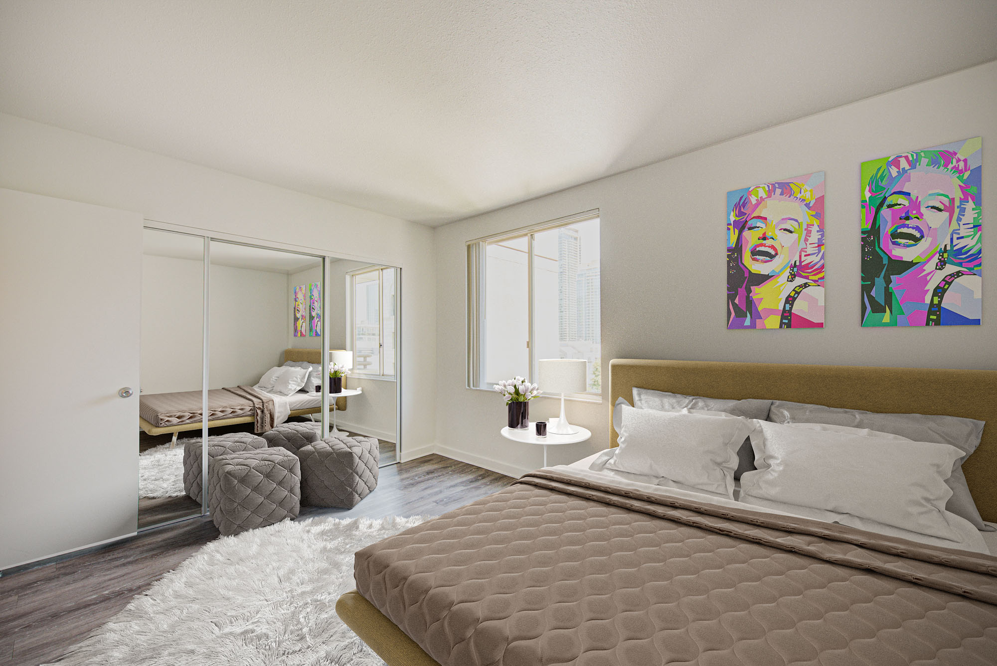 A bedroom with a closet with mirror doors, hard wood floors and a large window at The Mets modern apartments in downtown LA