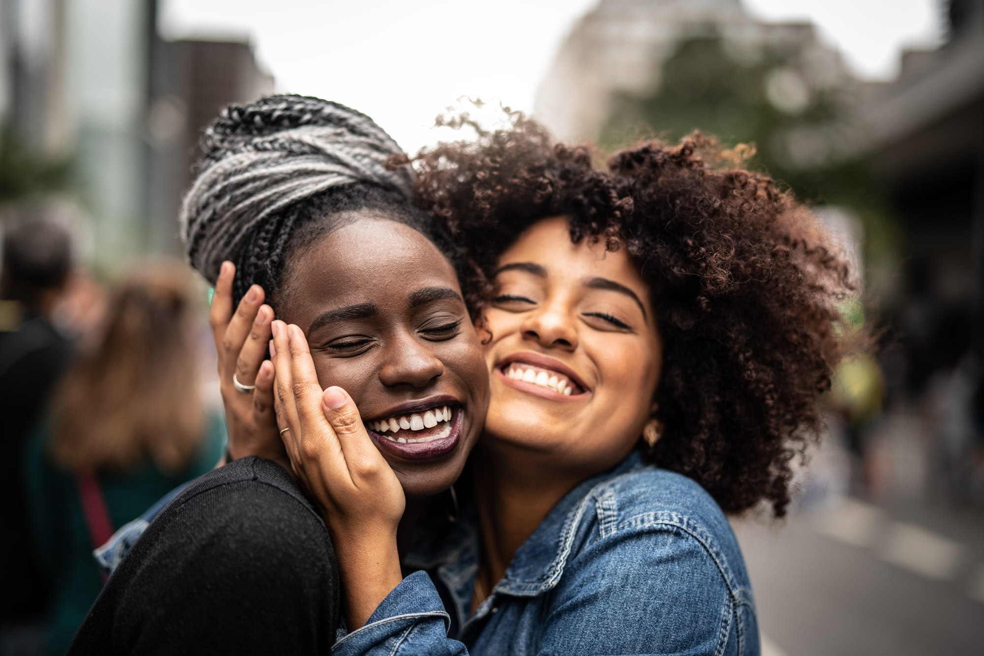 Two friends embracing each other in the South Park neighborhood in downtown Los Angeles