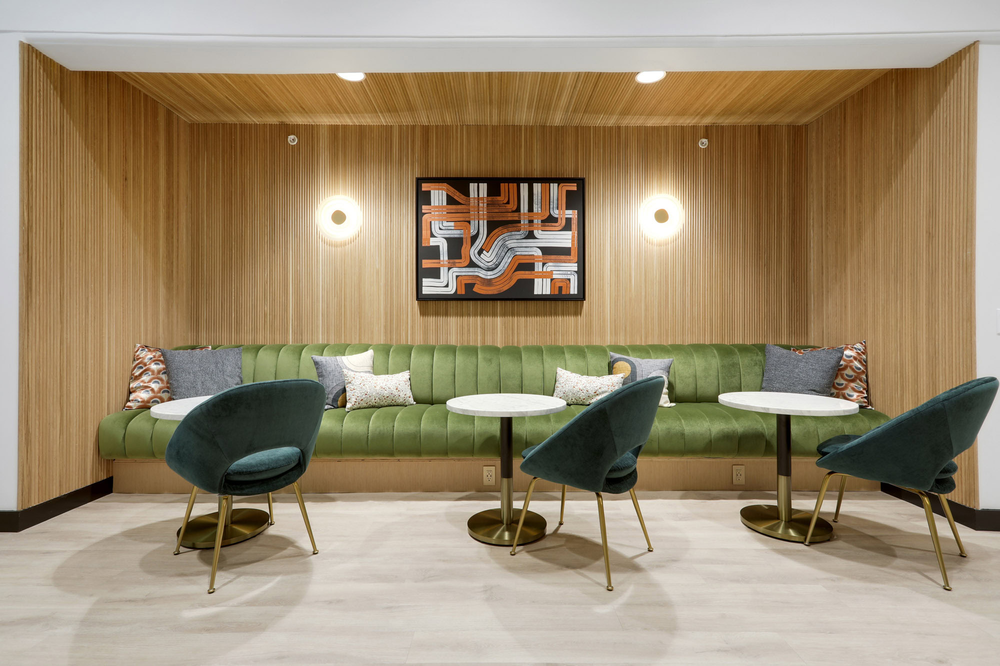 Suede green booth seating with wood panel walls and ambiant lighting at Metro 417's modern apartments in downtown LA