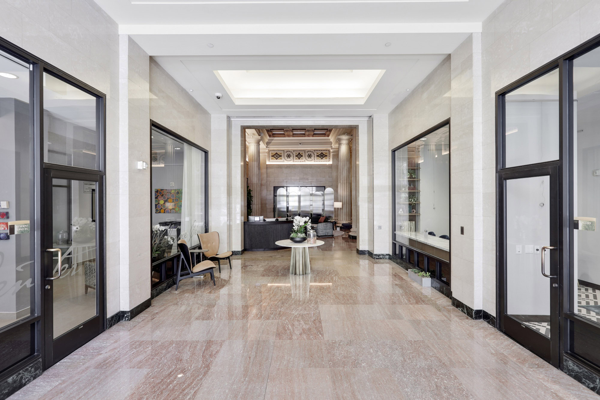 The lobby hallway leading to the front desk of Metro 417's modern apartment building in downtown LA