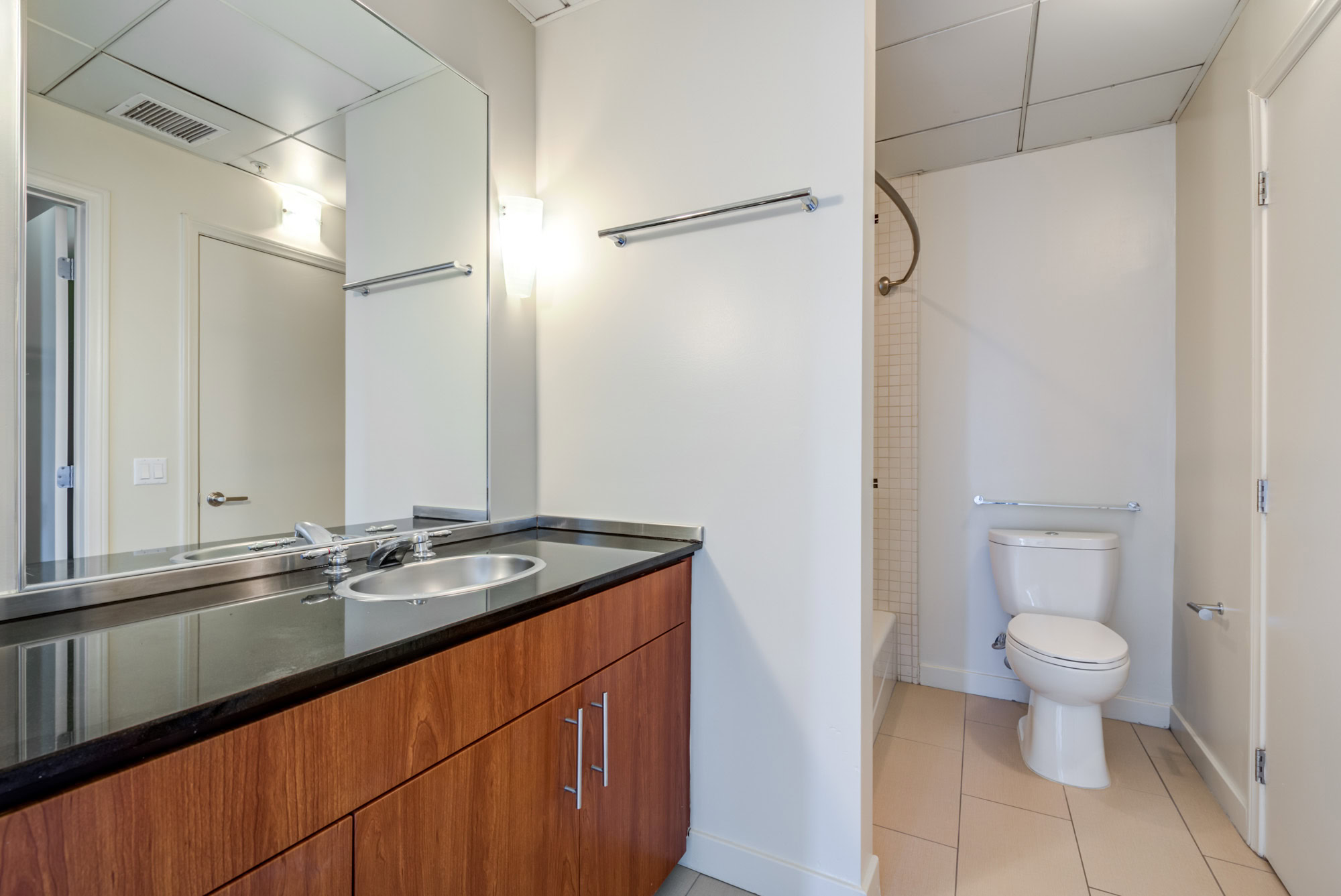 A bathroom with a spacious vanity counter in a Metro 417 apartment in downtown LA