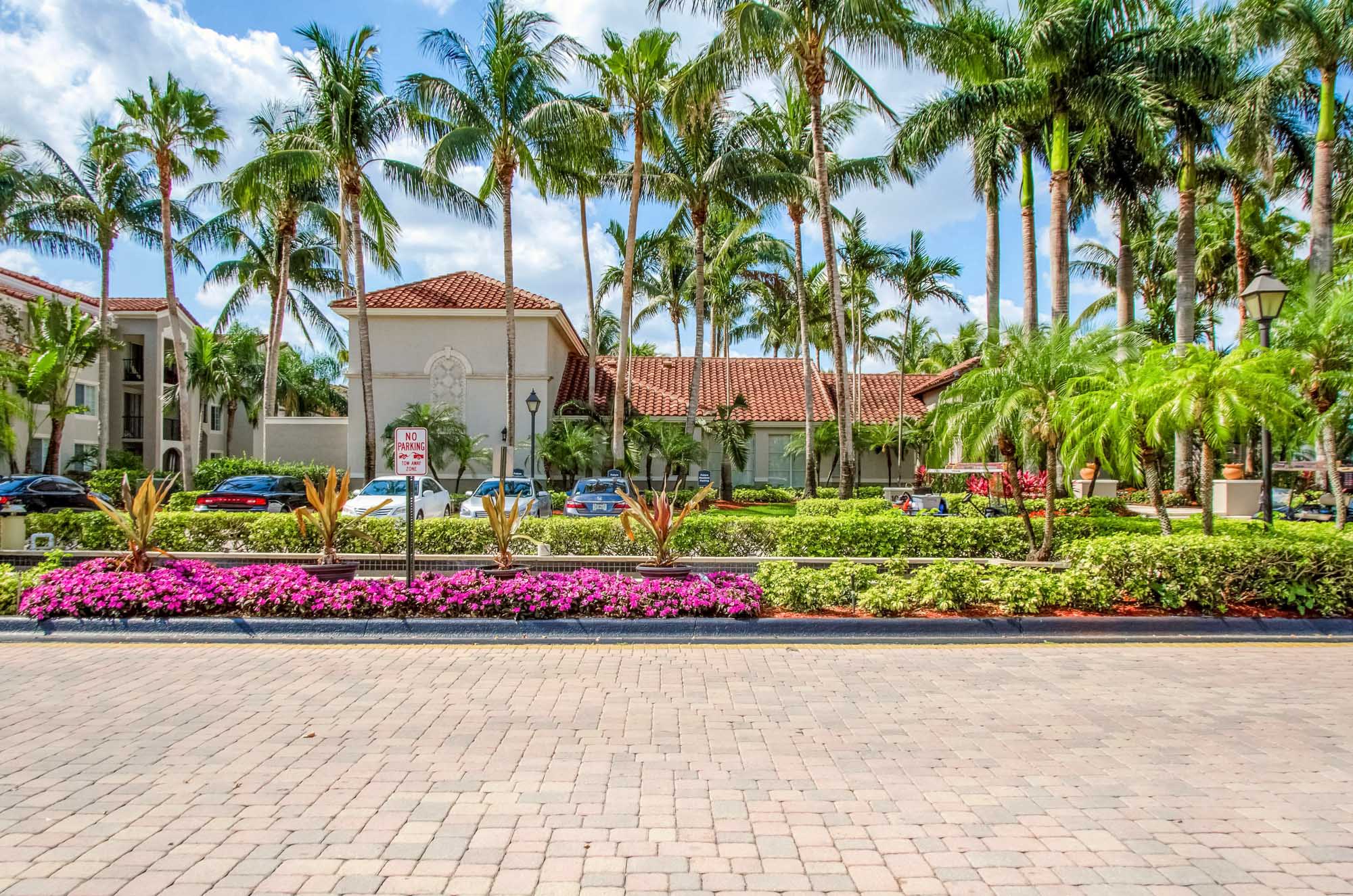 A driveway and garden in front of the main office building of the Miramar Lake apartments in Fort Lauderdale, FL