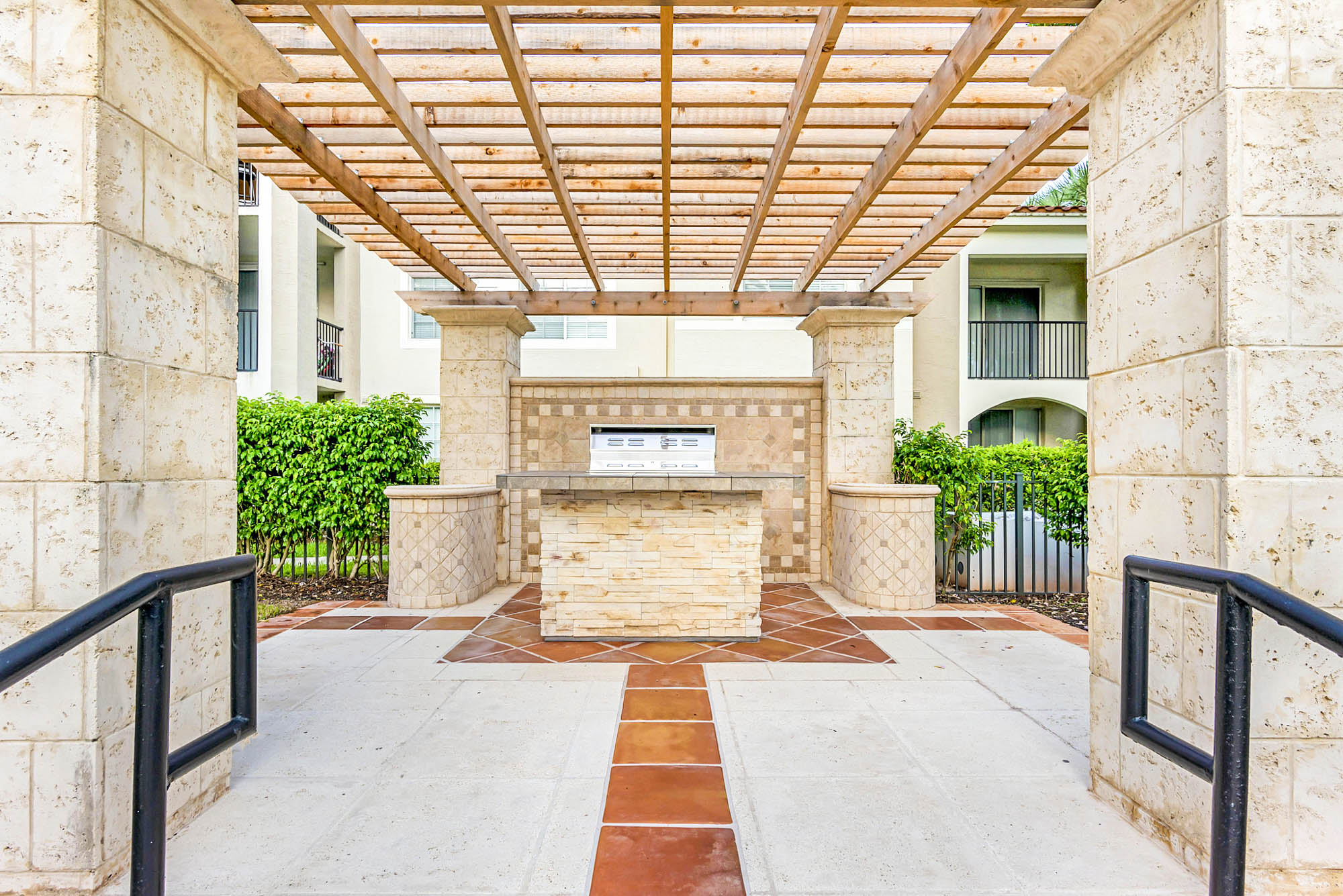 A grilling station under a pergola cover at Miramar Lakes luxury apartments in Fort Lauderdale