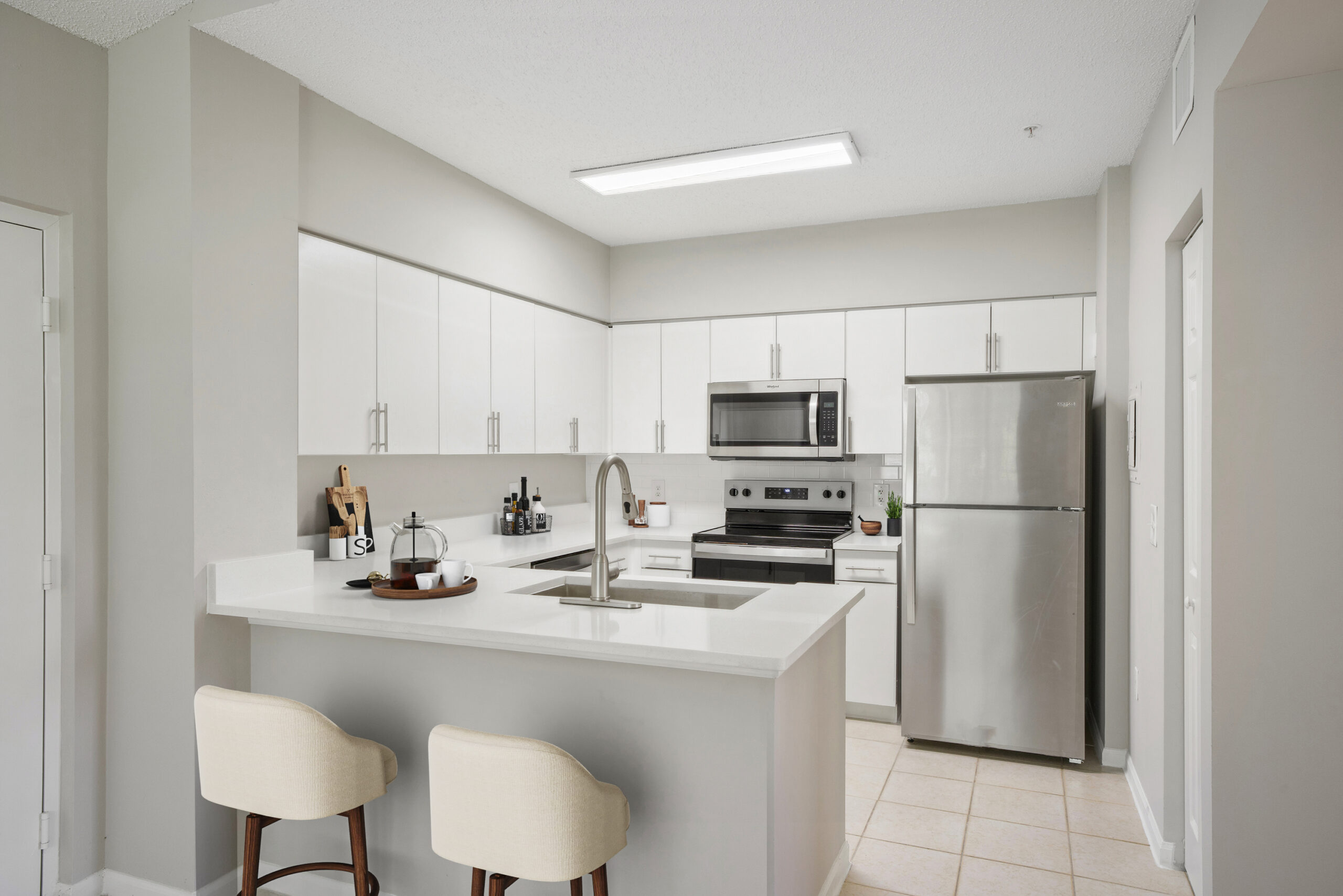 A kitchen with a peninsula in a Miramar Lakes apartments in Fort Lauderdale, FL