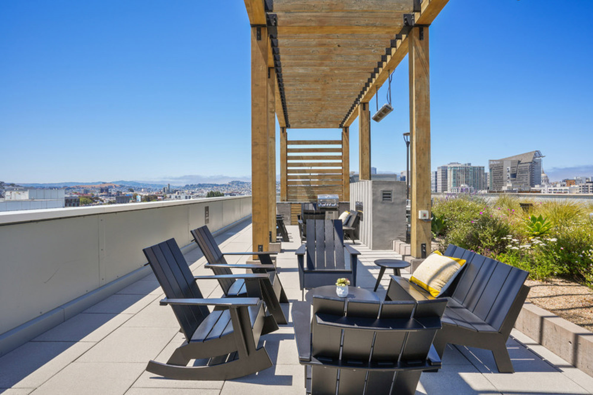 Two seating area under a pergola on the terrace of the Mosso apartments in downtown San Francisco