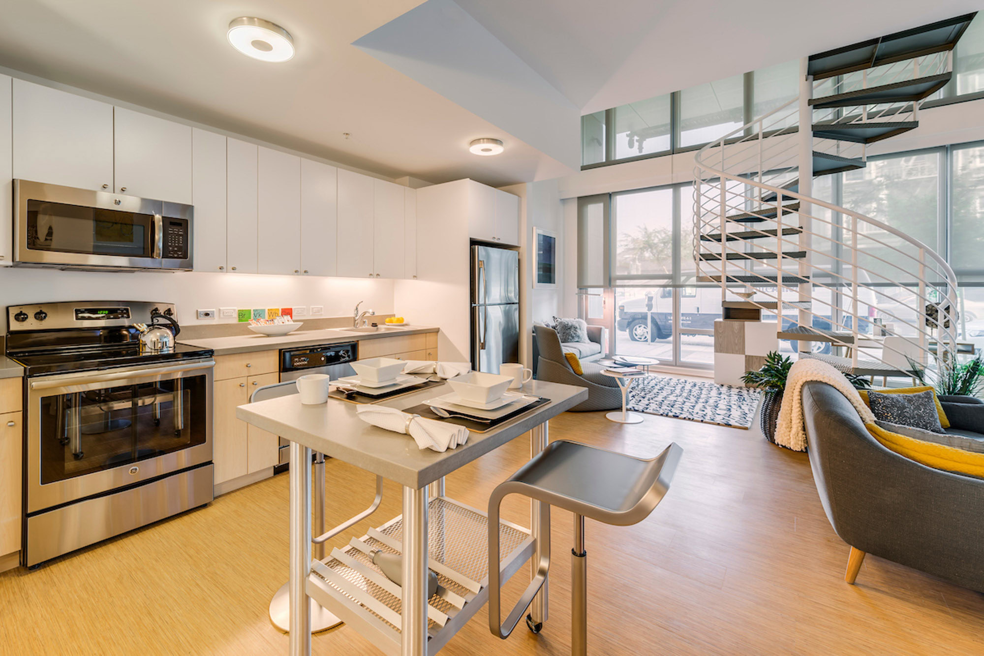 A dining room and kitchen in an open plan apartment with staircase at Mosso apartments in San Francisco