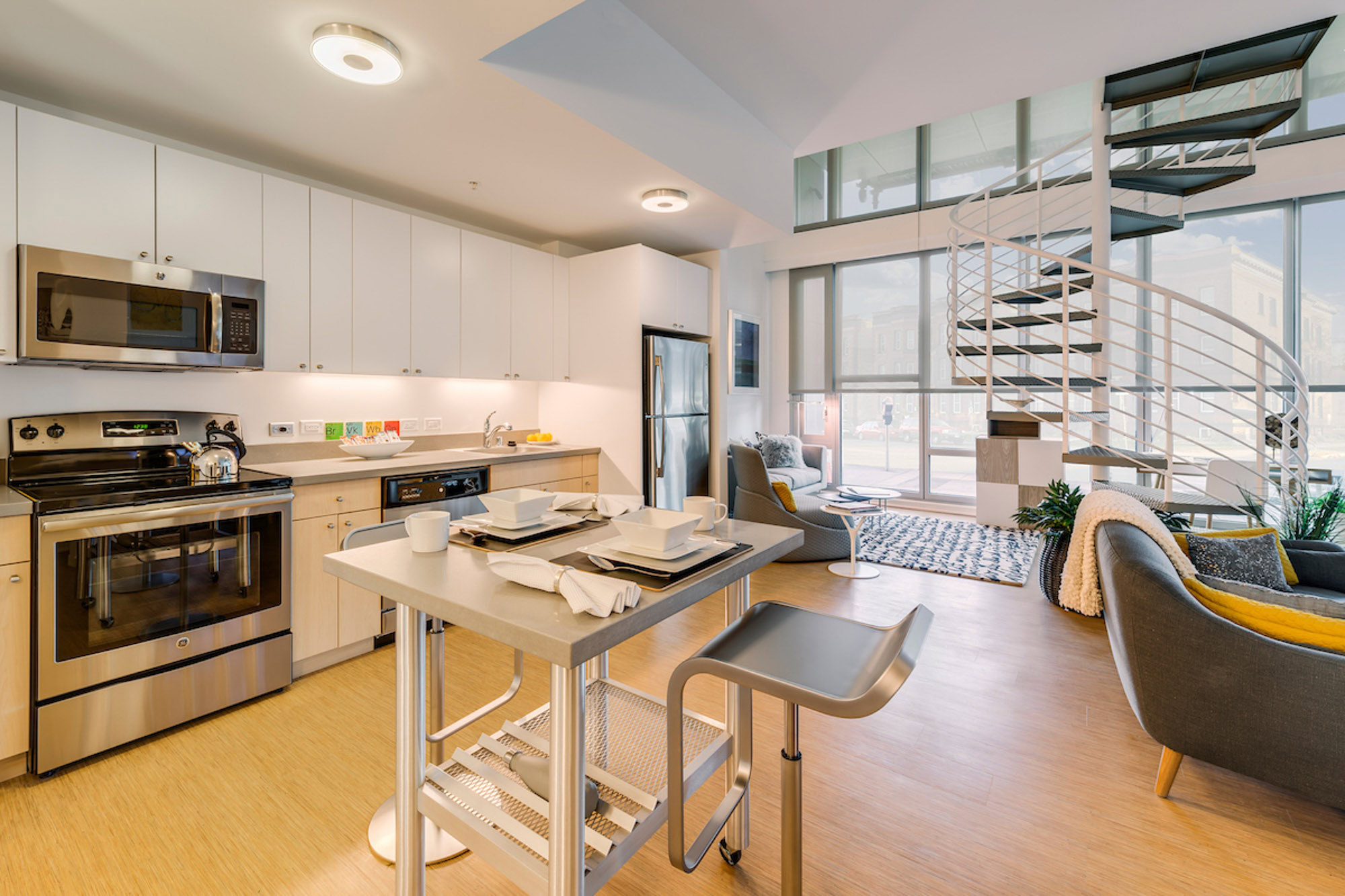 A dining room and kitchen in an open plan apartment with staircase at Mosso apartments in San Francisco