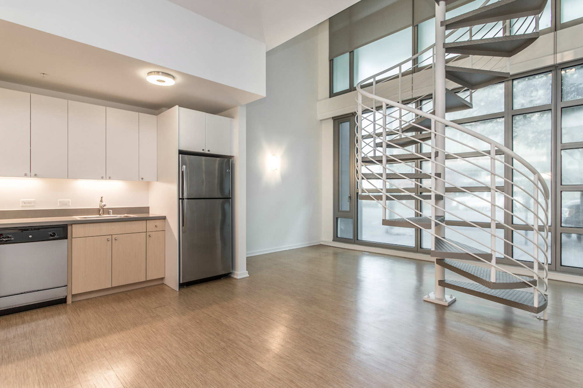 A kitchen area with a spiral staircase in the middle at the Mosso apartments in San Francisco