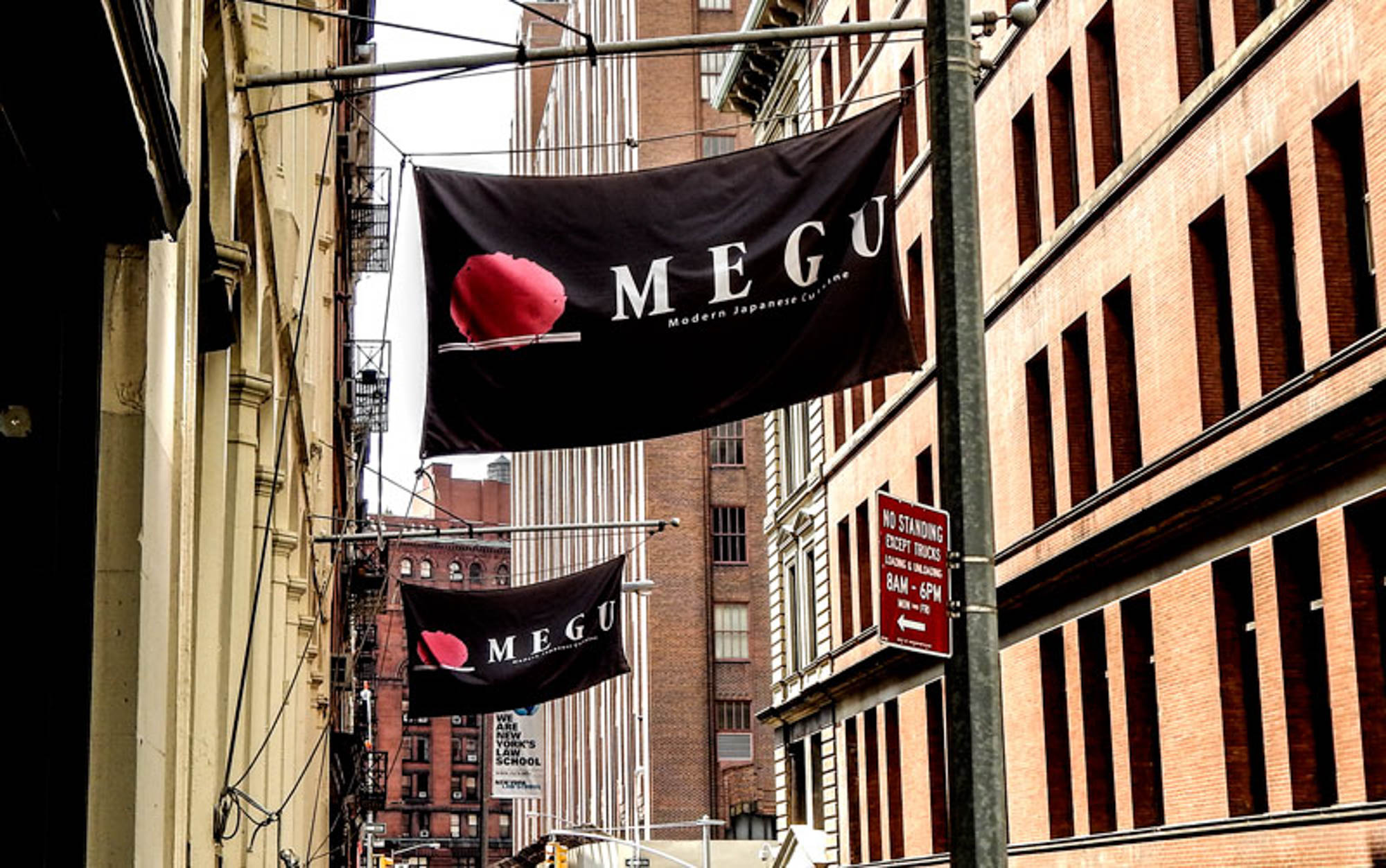 A sign for Megu by 111 Worth apartments in New York, NY.