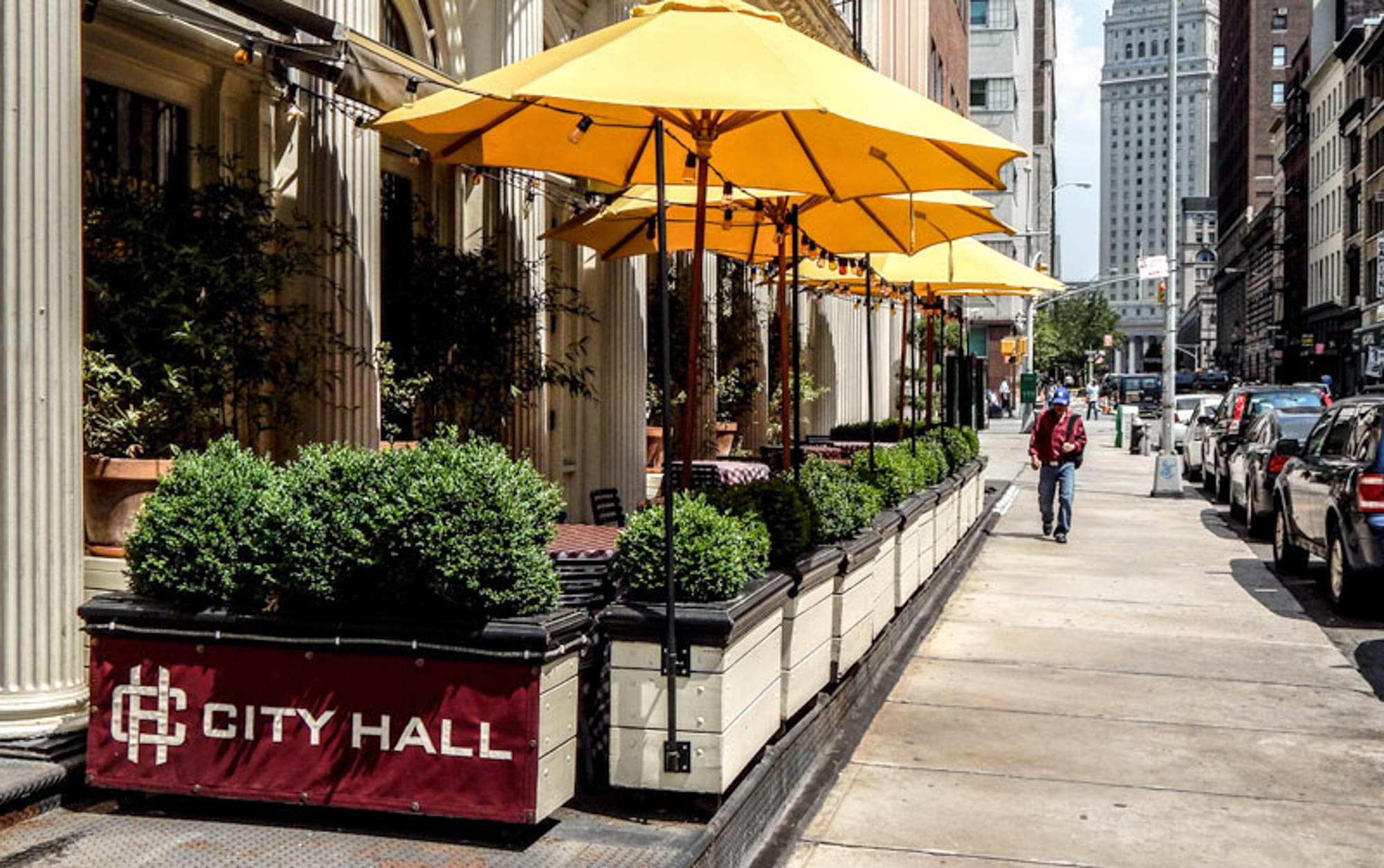 A street with outdoor seating by 111 Worth apartments in New York, NY.