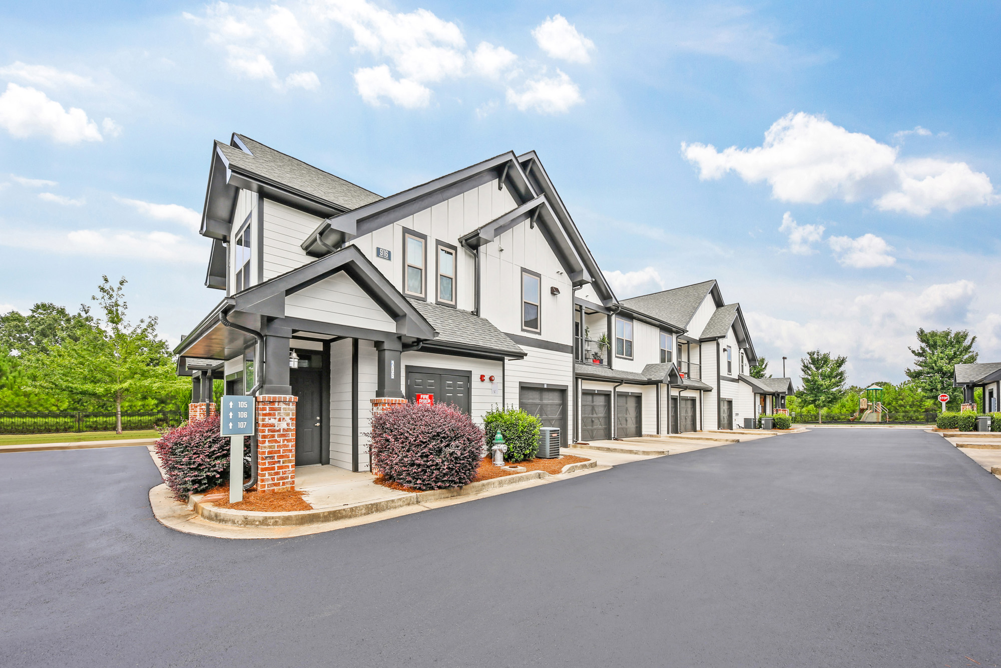 View of the back entrance to Park 9 apartments featuring attached garages.