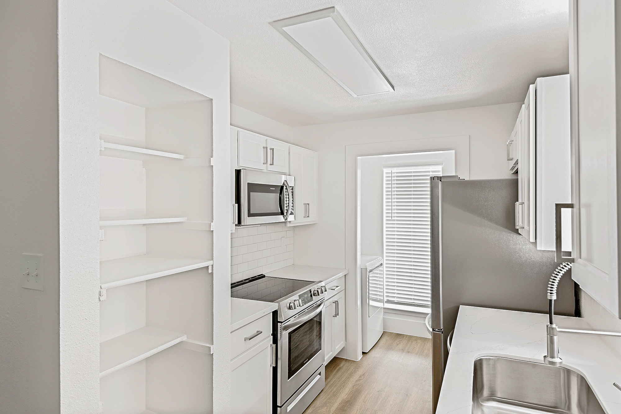 The kitchen of an apartment at The Arbors of Wells Branch in Austin, TX.