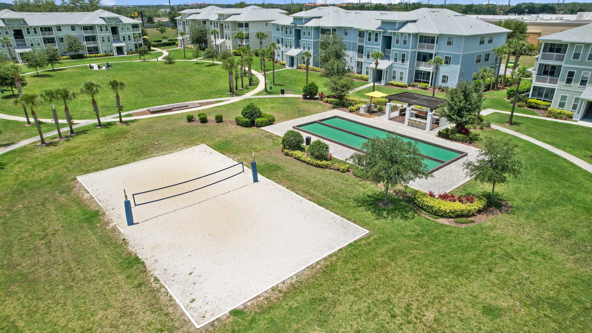 The sand volleyball and bocce ball courts at Domain apartments in Kissimmee, Florida.