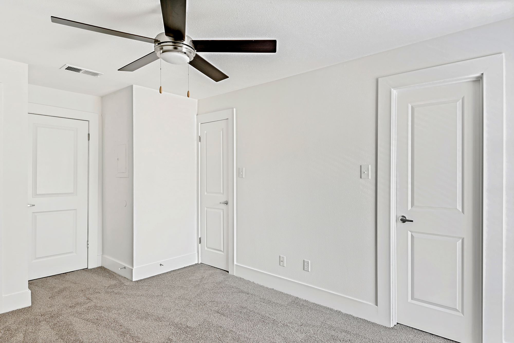 The bedroom of an apartment at The Arbors of Wells Branch in Austin, TX.