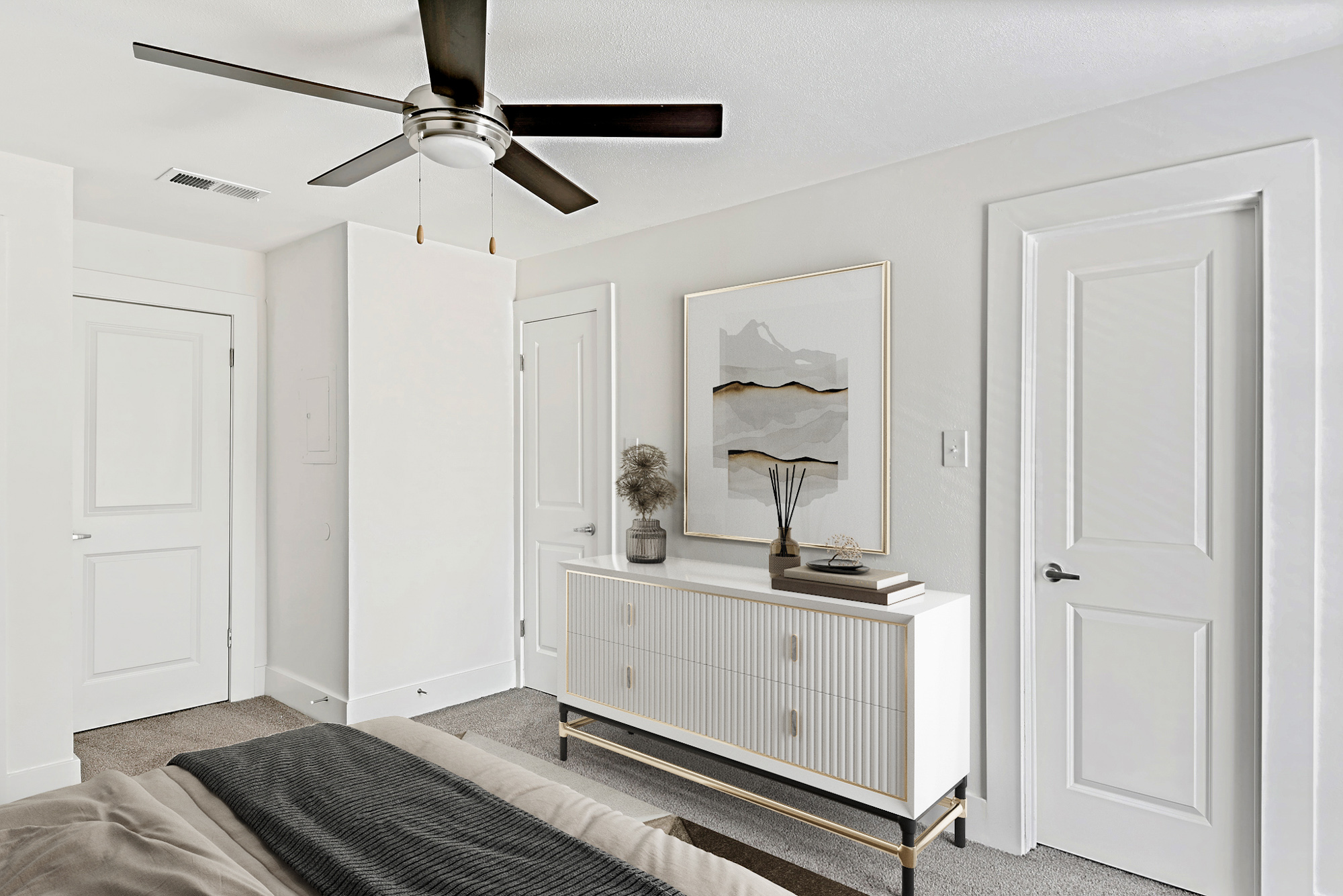 The bedroom of an apartment at The Arbors of Wells Branch in Austin, TX.