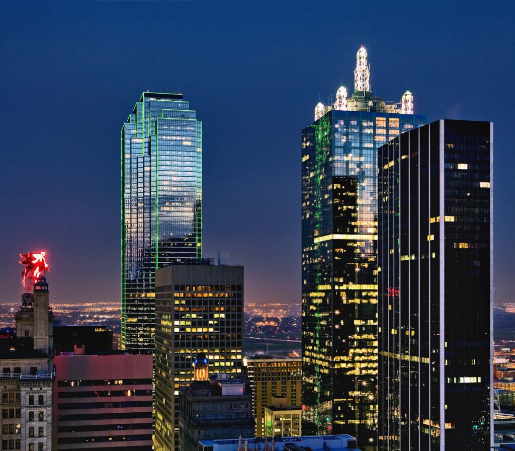 City views at night of the Dallas skyline in from The Merc apartments in Mercantile Place in Dallas TX