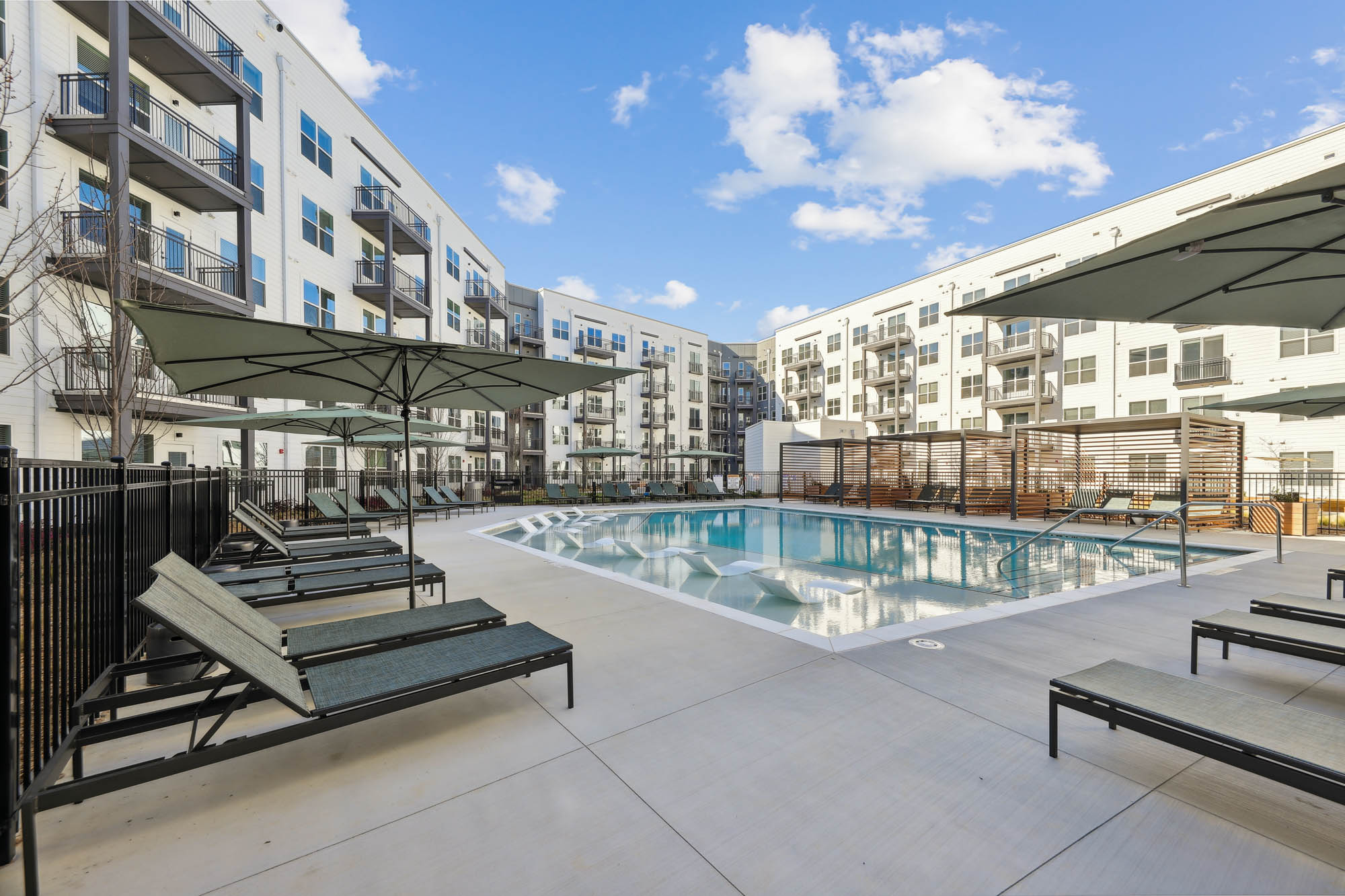 A pool with lounging chairs at Tallulah apartments in Cumberland, Georgia.