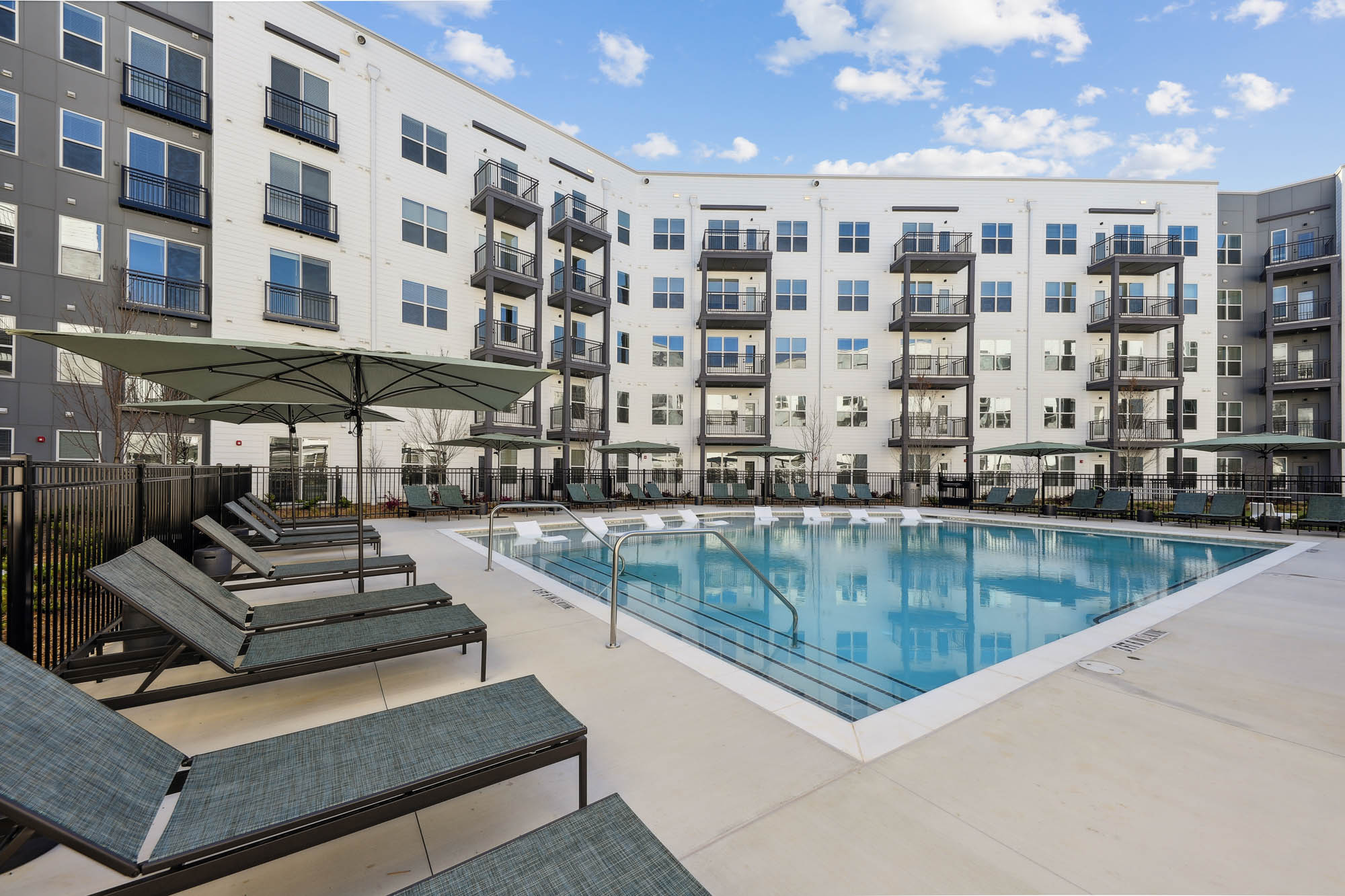A pool with lounging chairs at Tallulah apartments in Cumberland, Georgia.