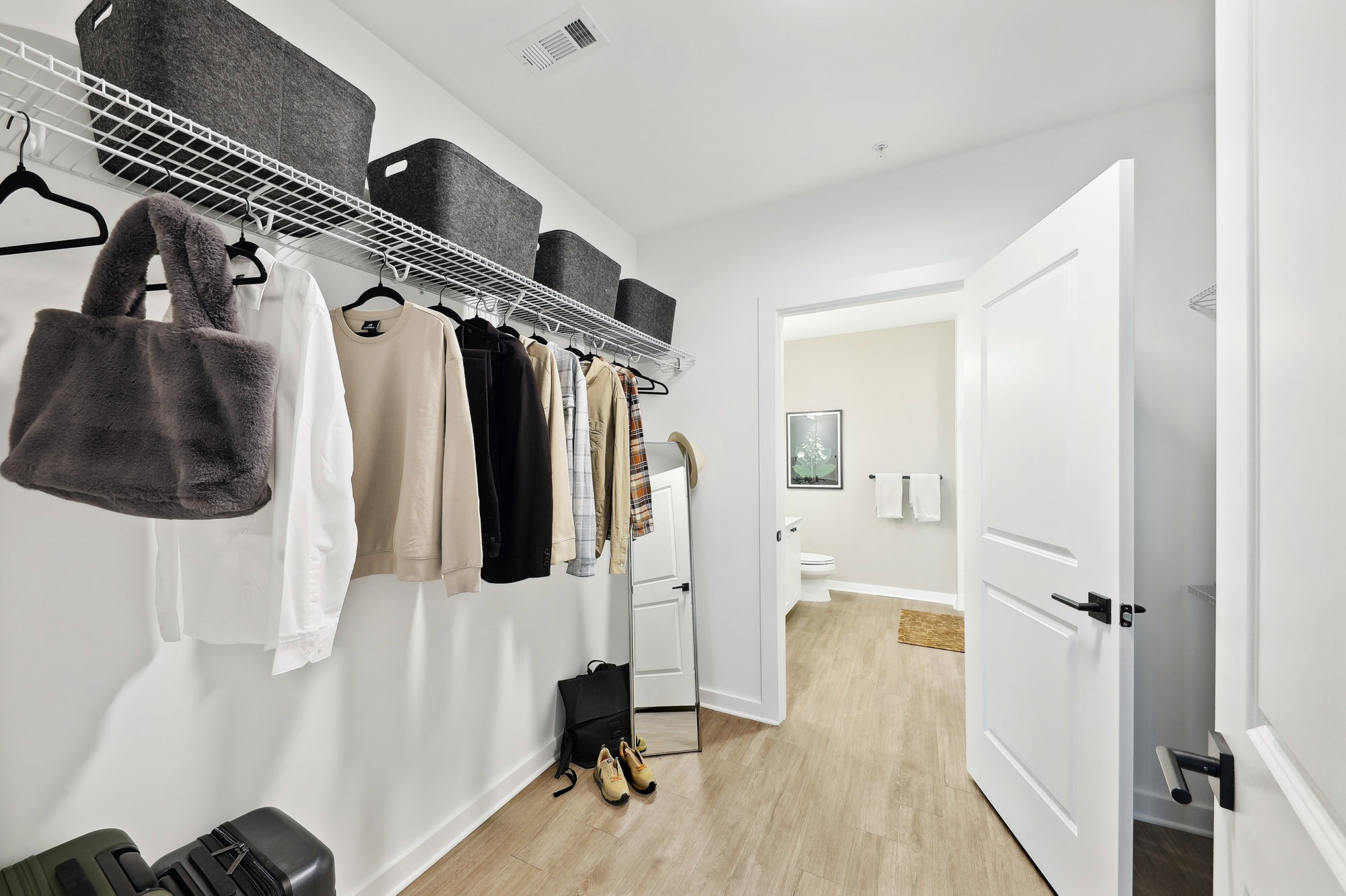 A spacious walk-in closet in a Tallulah apartment in Cumberland, Georgia.